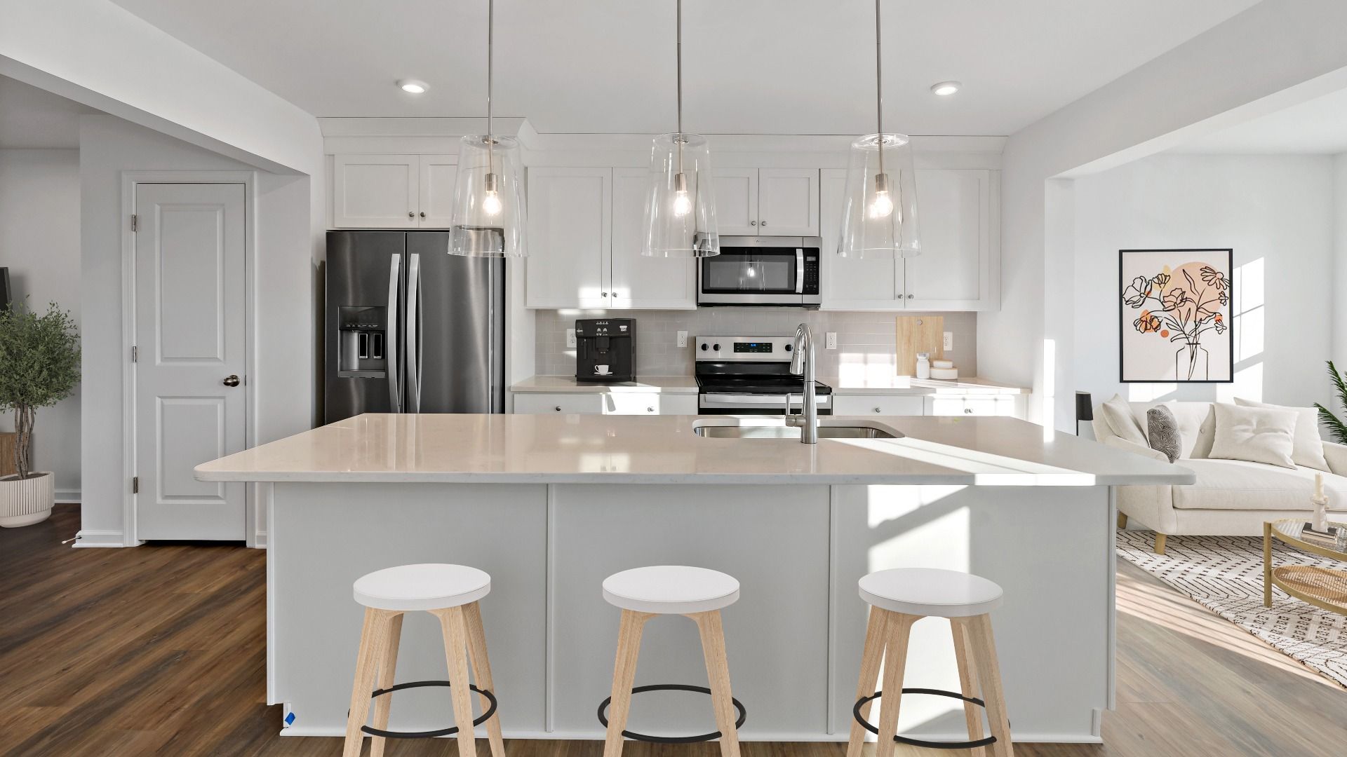 York II Garage kitchen with island seating, pendant lighting, and stainless steel appliances.