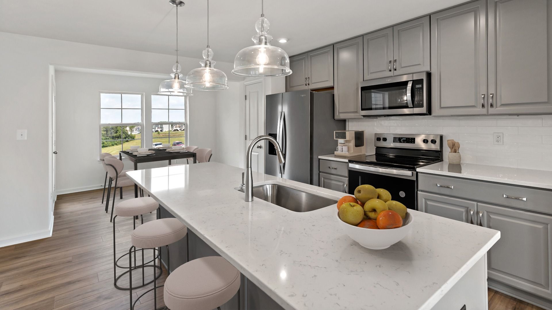 York II Garage floor plan kitchen with extended island, bar seating, and sleek grey cabinets.