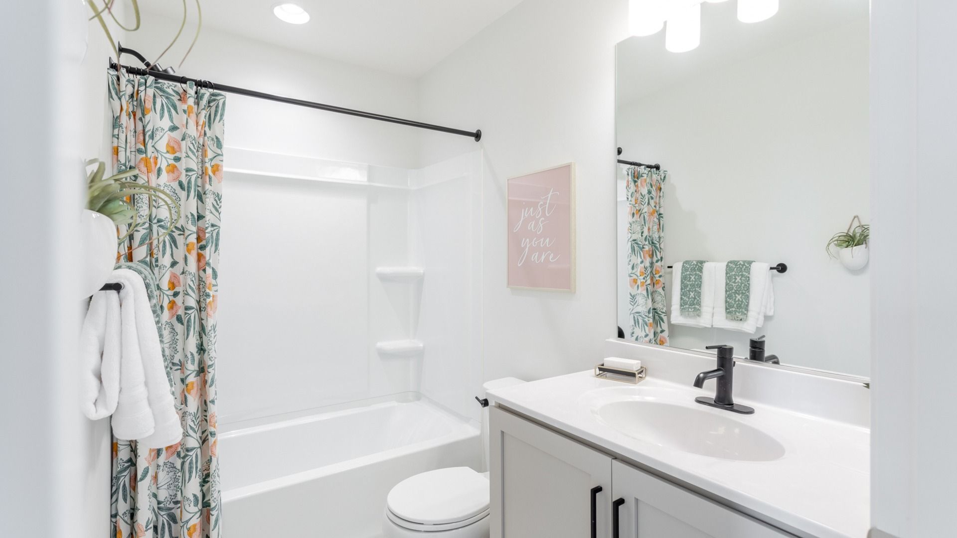 York II Garage floor plan hall bath with bright fixtures and sleek white countertop.