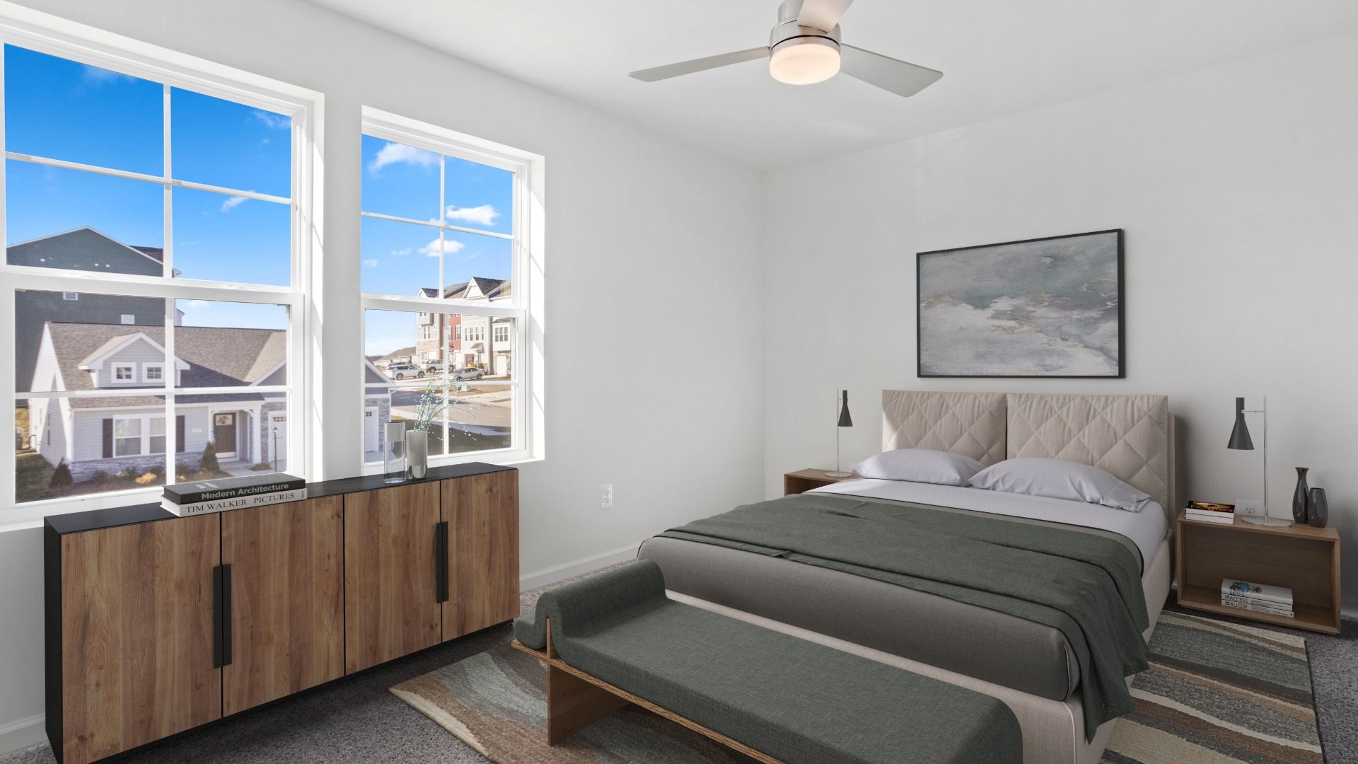 Secondary bedroom in the Whitehall II with large windows that fill the space with natural light.