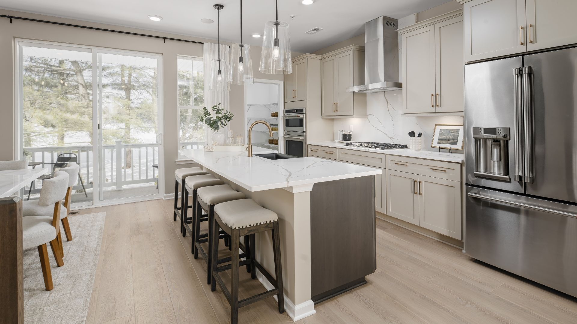 A generous center island with an extended countertop creates a stylish bar-style seating area