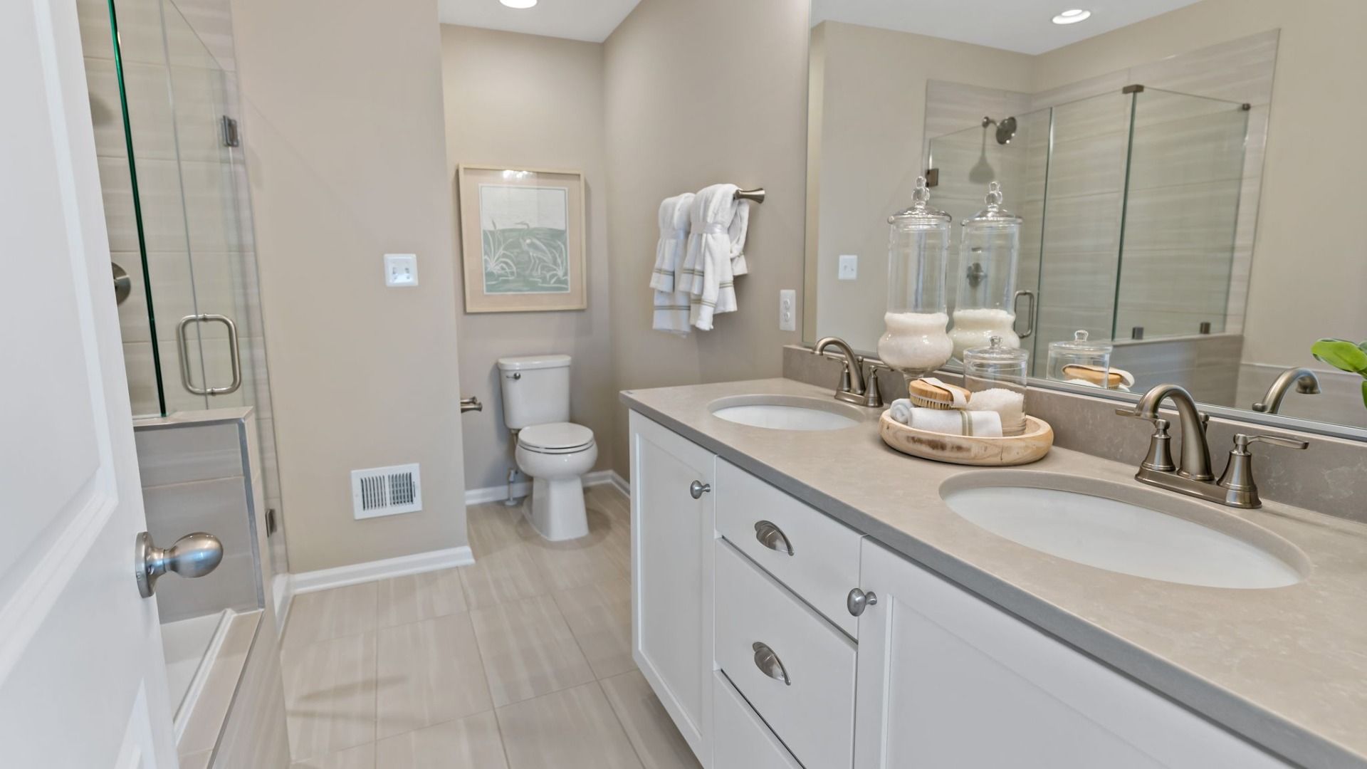 The owners' bath with dual vanity and a shower.