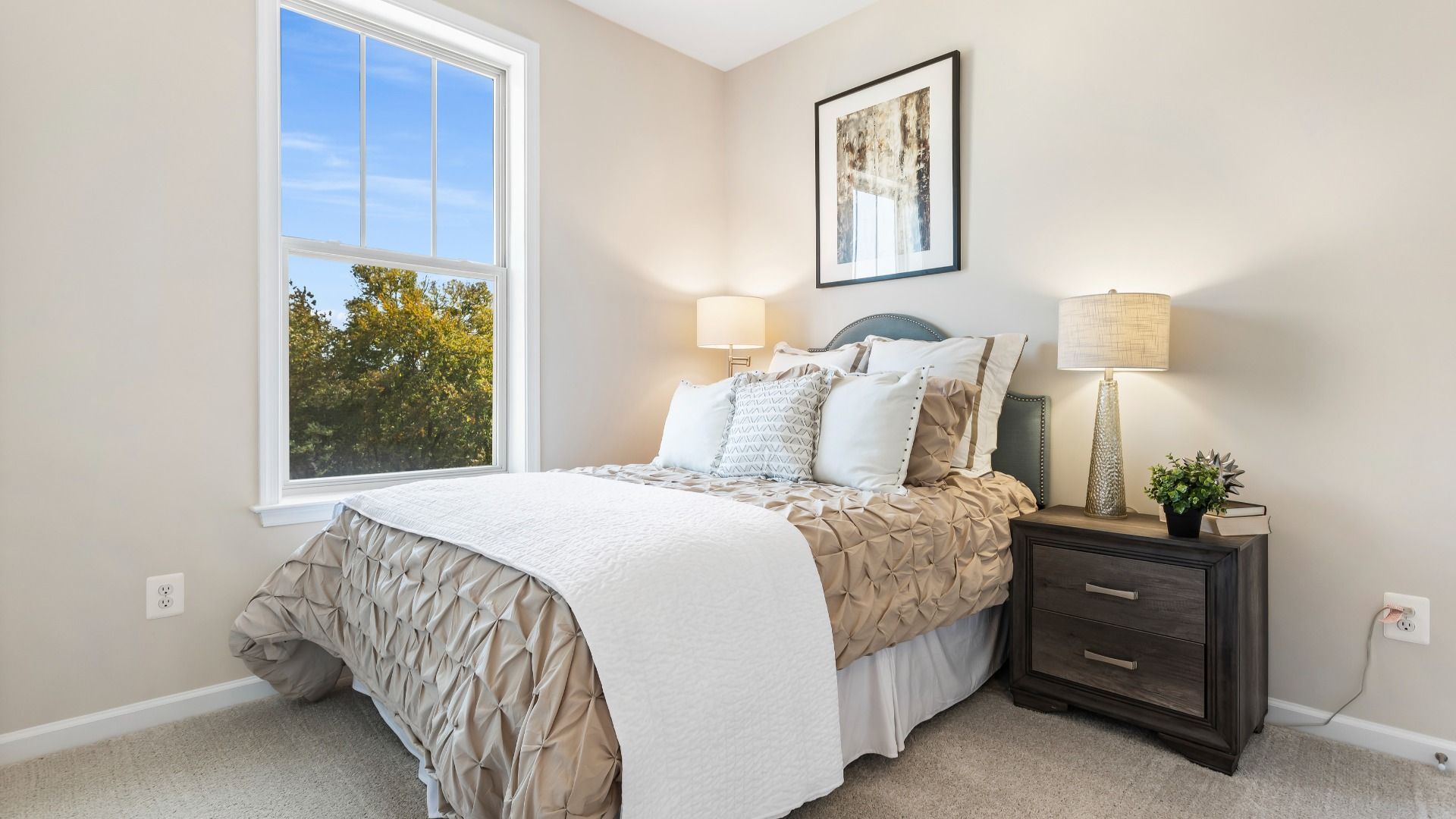 Carpeted secondary bedroom with large window at a DRB Homes Upton II Model at the Canterbury Station Community.