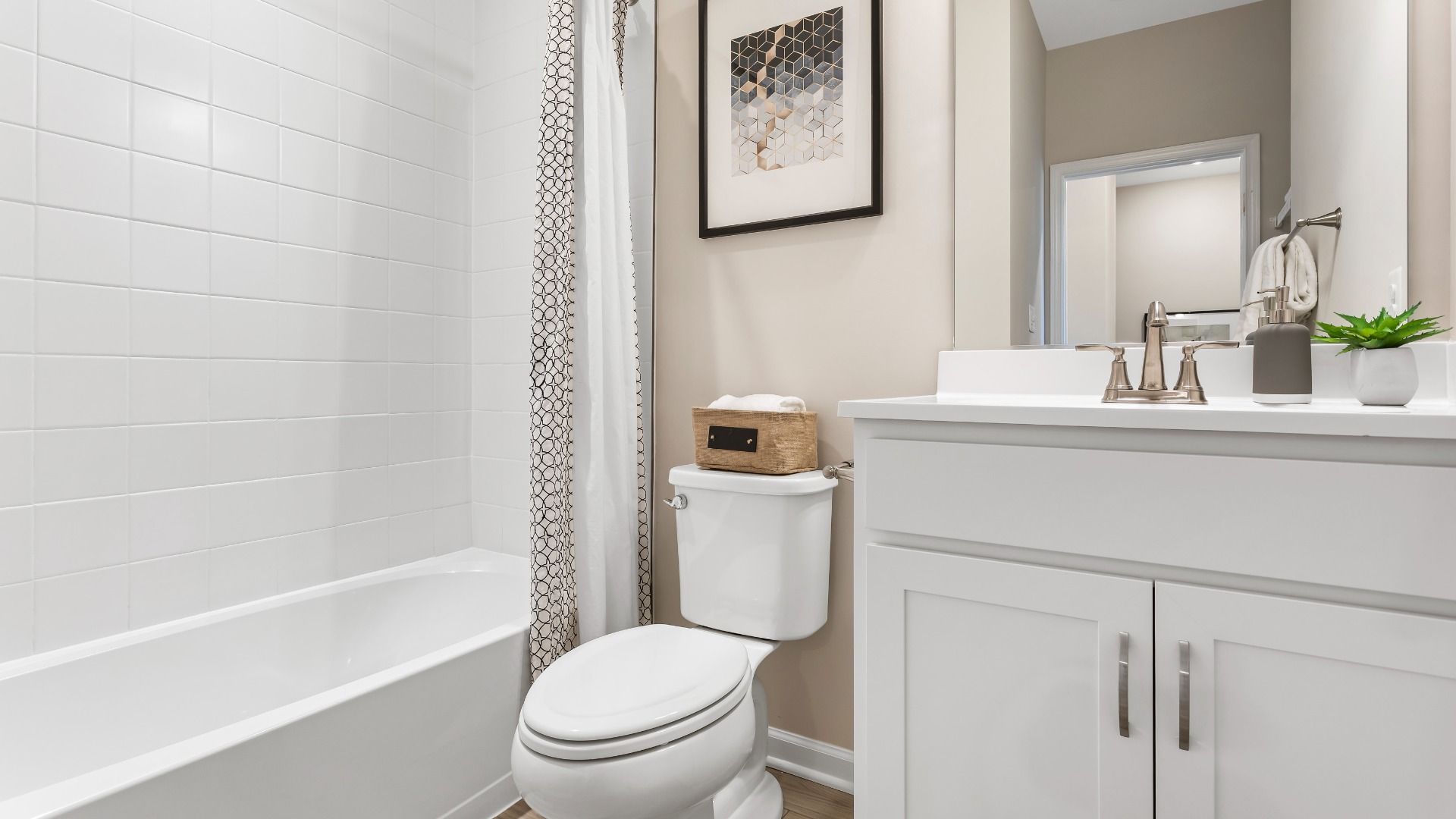 Full bath with white vanity and shower/tub combo at a DRB Homes Upton II Model at the Canterbury Station Community.