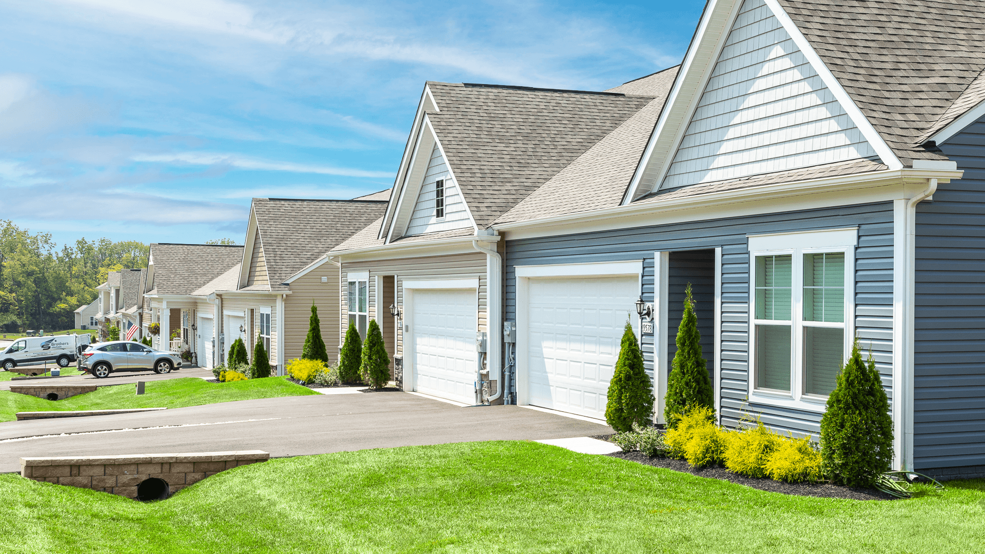 A side view showcasing multiple home exteriors, highlighting the community’s design and layout.