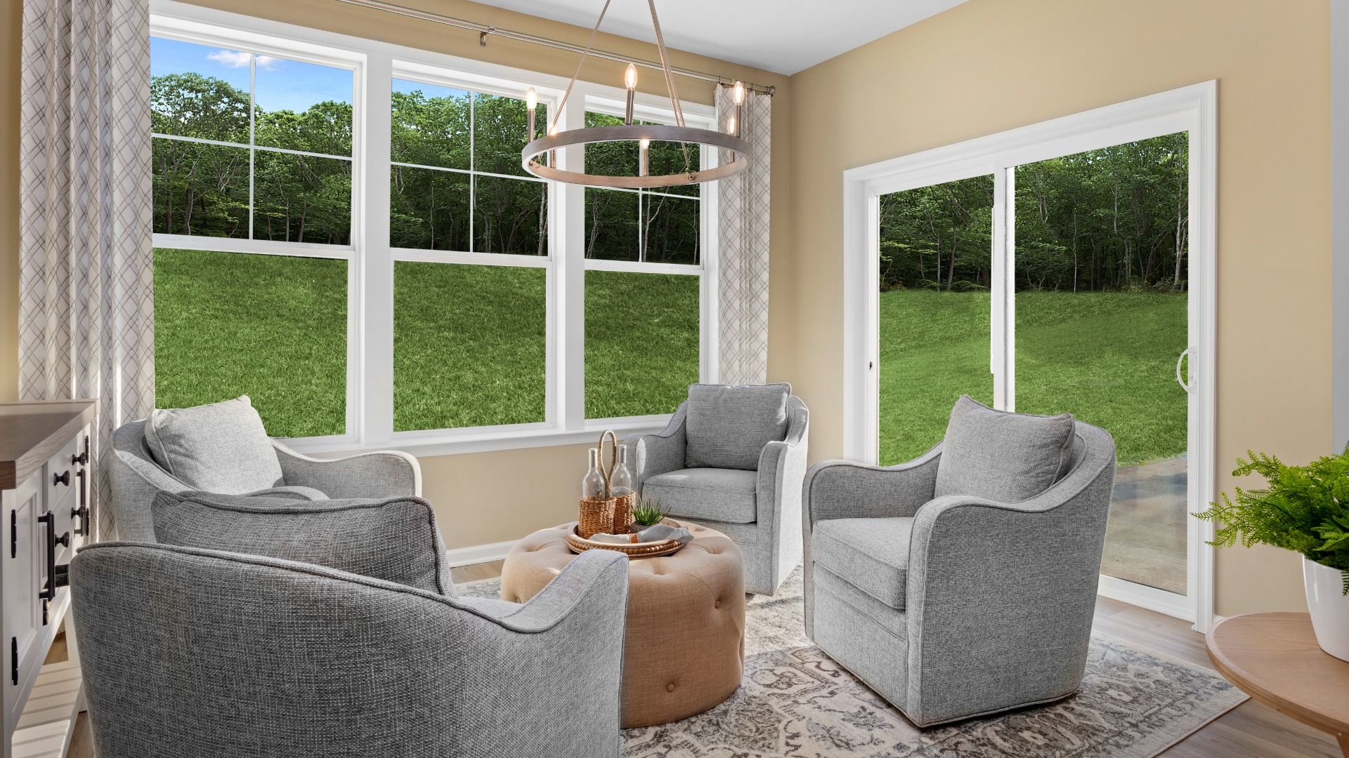 Enjoy the bright morning room in the Starling II, featuring large windows and a sliding glass door.