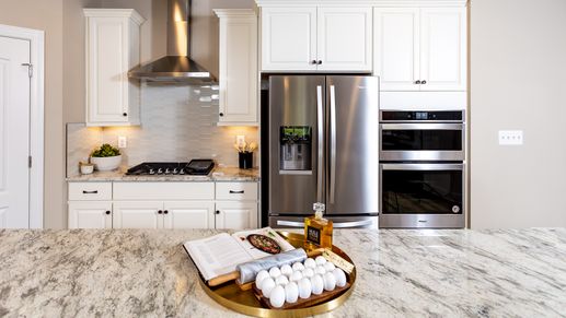 The Kitchen with Whirlpool Appliances in the DRB Homes Finch Model at Rosehill Manor