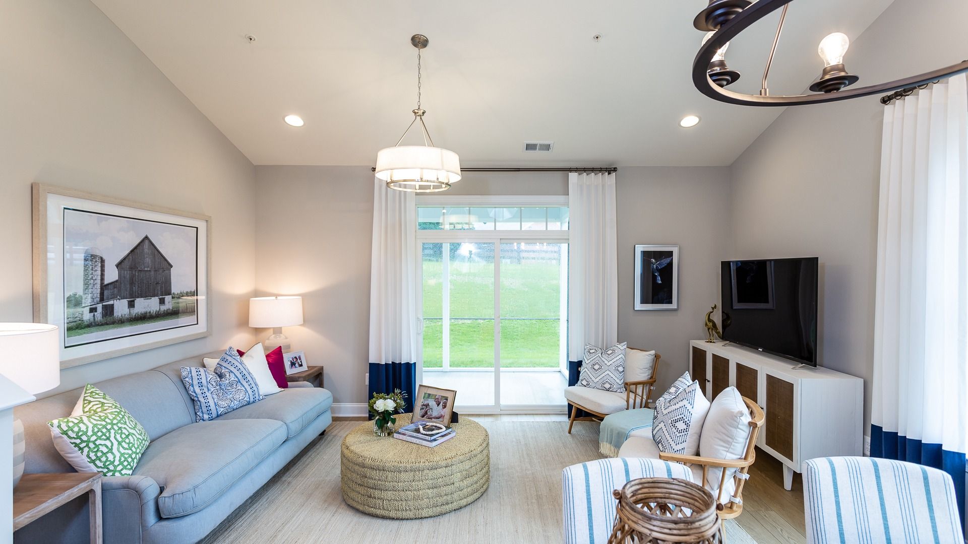 The Family Room with Comfortable Seating and Media Center in the DRB Homes Starling II Model at Rosehill Manor