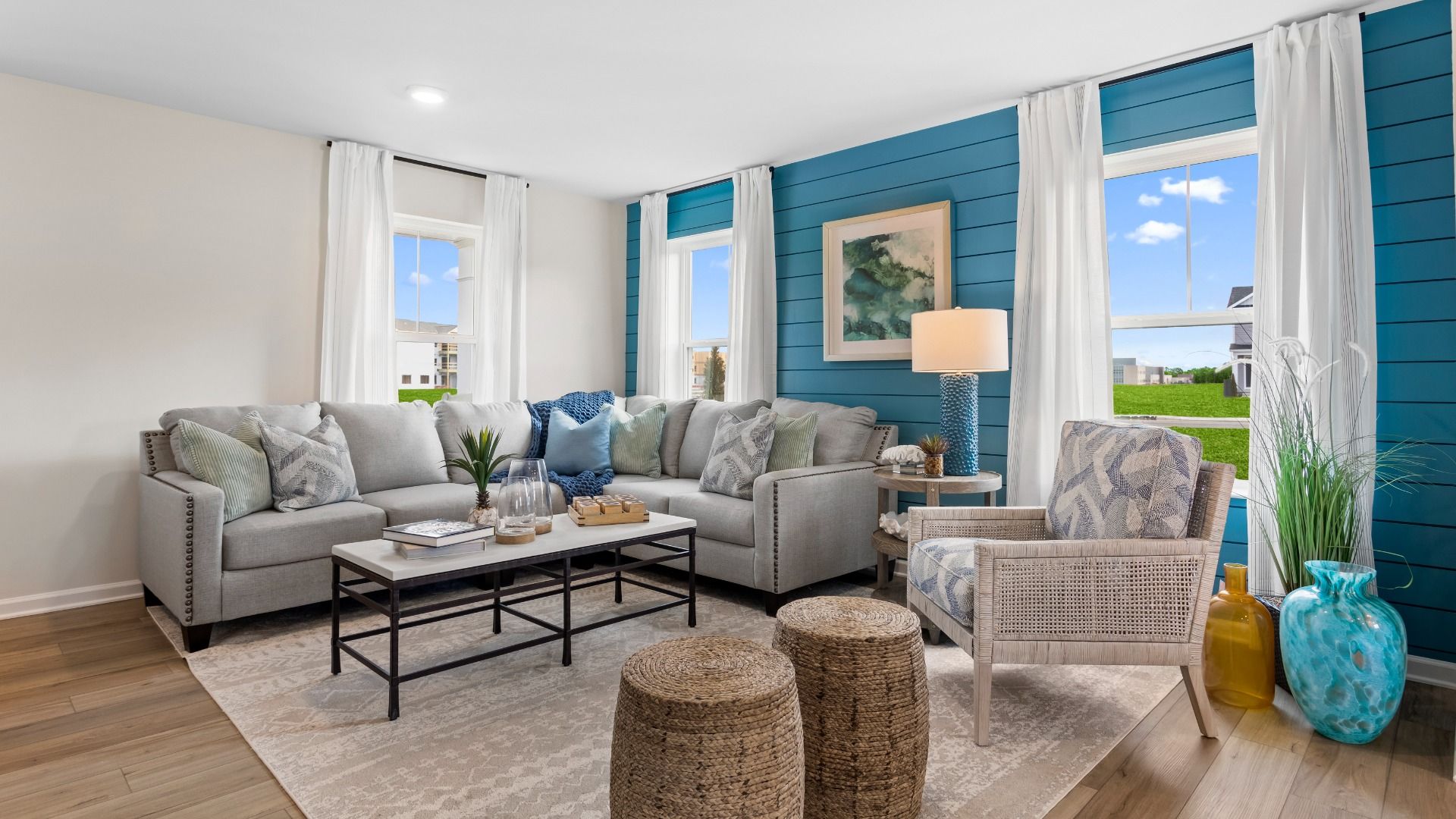 The Living Room with Comfortable Seating in a DRB Homes Whitehall II Model Home