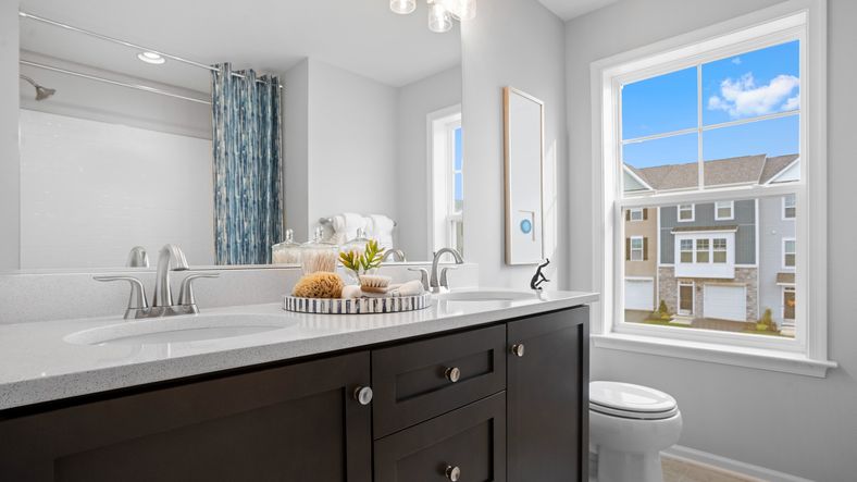 A spacious and sleek hall bathroom in the Bridgeport II, offering a stylish, functional layout.