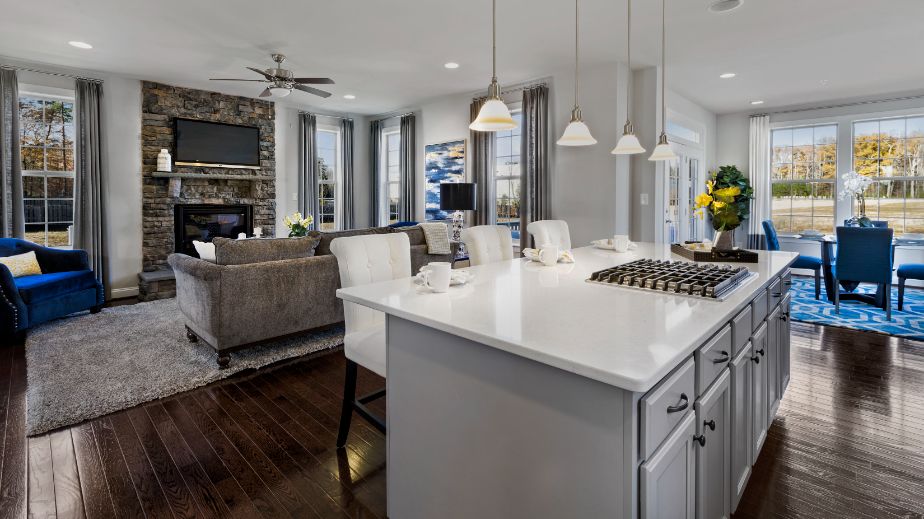 Open kitchen and family room with large island in a DRB Homes Newbury II home plan at Huntfield.