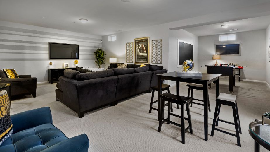 Carpeted finished lower level in a DRB Homes Newbury II home plan at Huntfield.