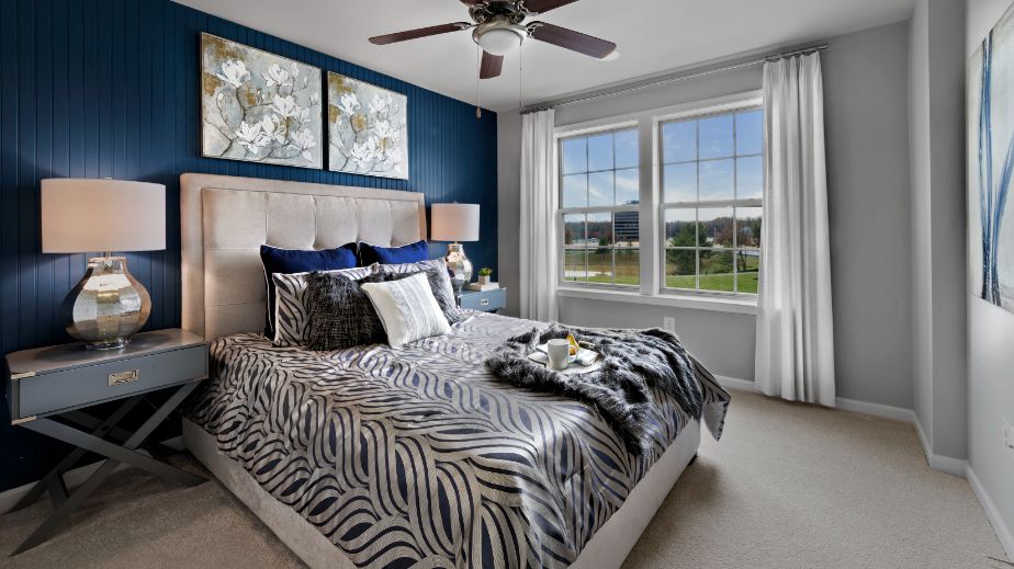 Carpeted secondary bedroom with double window in a DRB Homes Newbury II home plan at Huntfield.