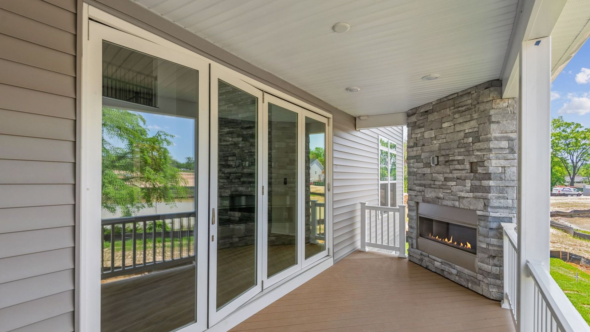 The Creighton's Rear Covered Deck Features an Outdoor Fireplace at South Lake