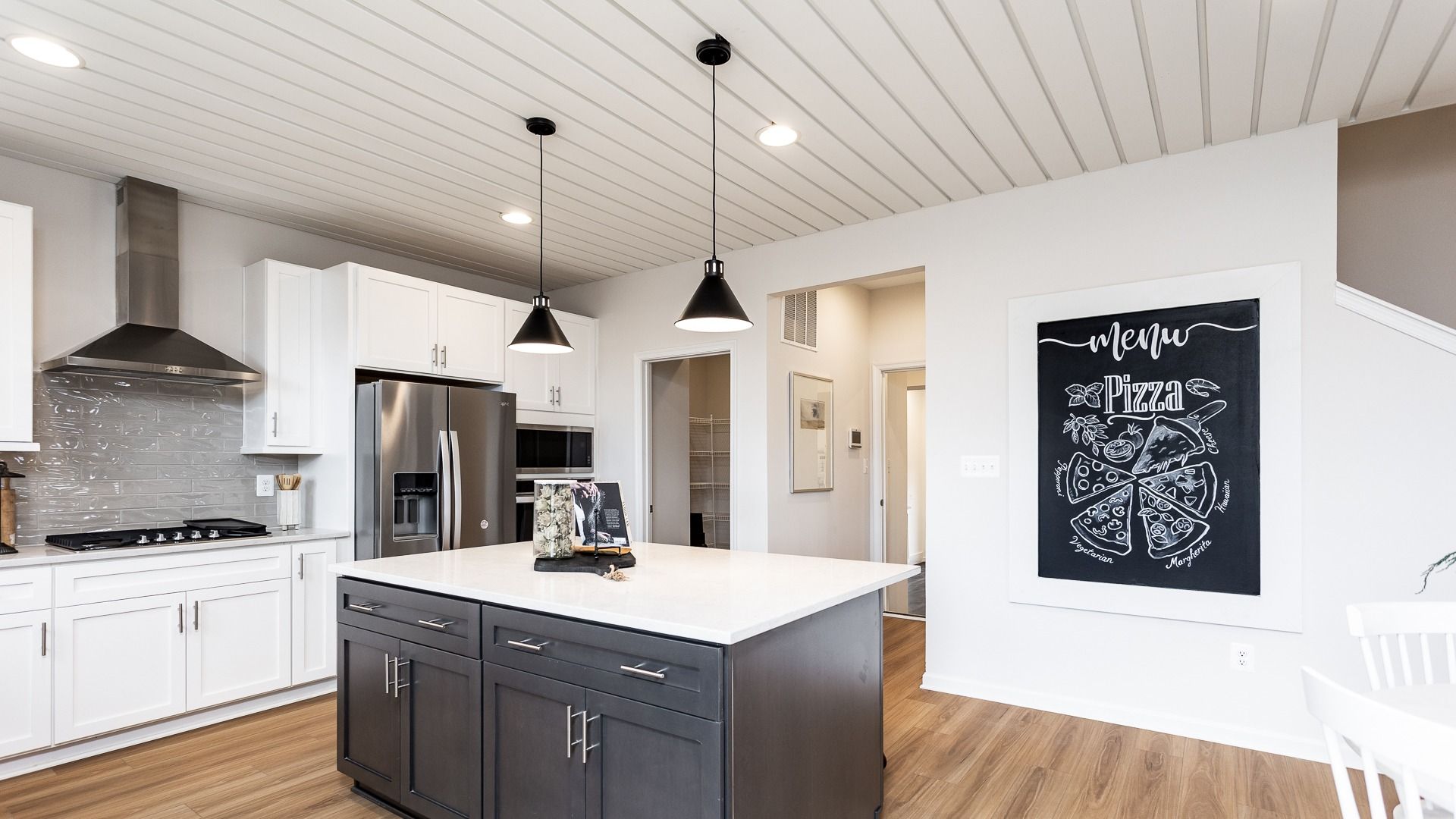 The kitchen in the Regent II floor plan features a large center island and Whirlpool appliances.