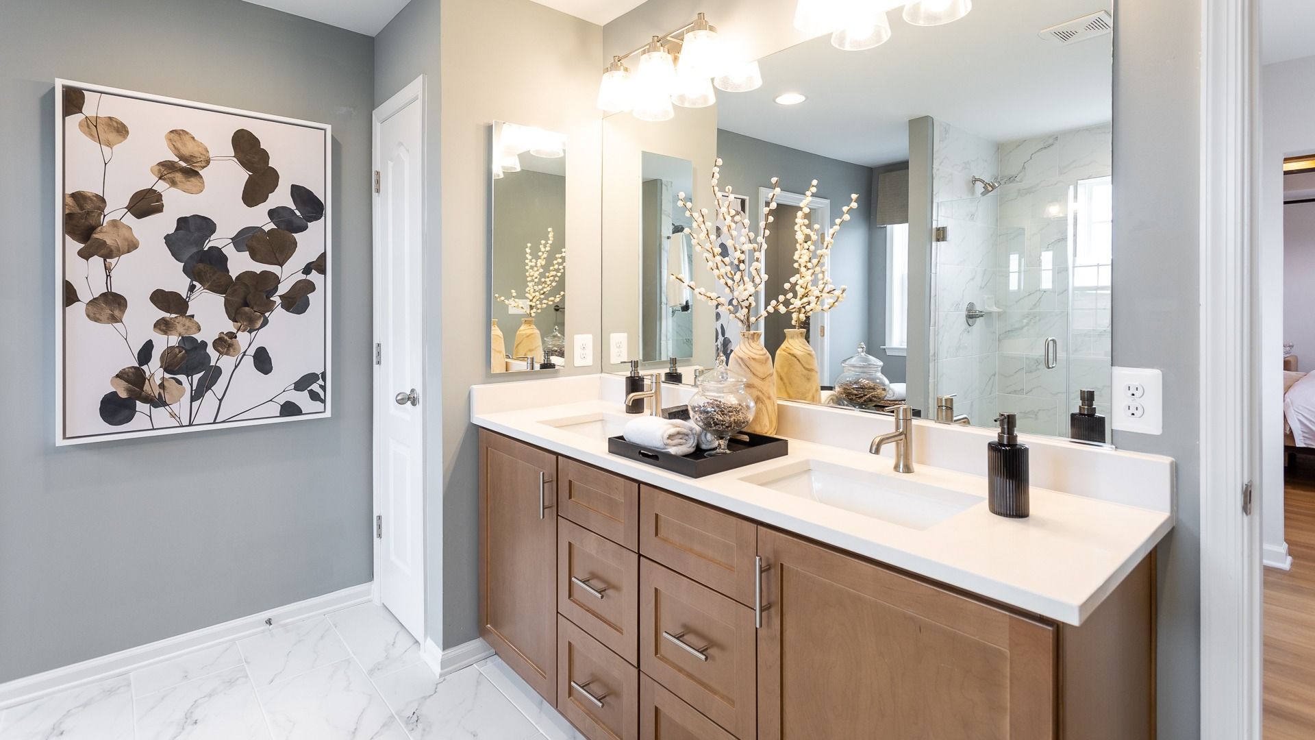 The owner’s bath in the Regent II floor plan features a Roman shower and dual sink vanity.
