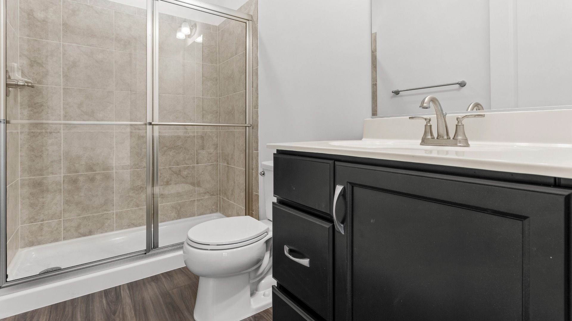 Full bath with glass shower in a DRB Homes Bridgeport home plan at Huntfield in Charles Town, WV