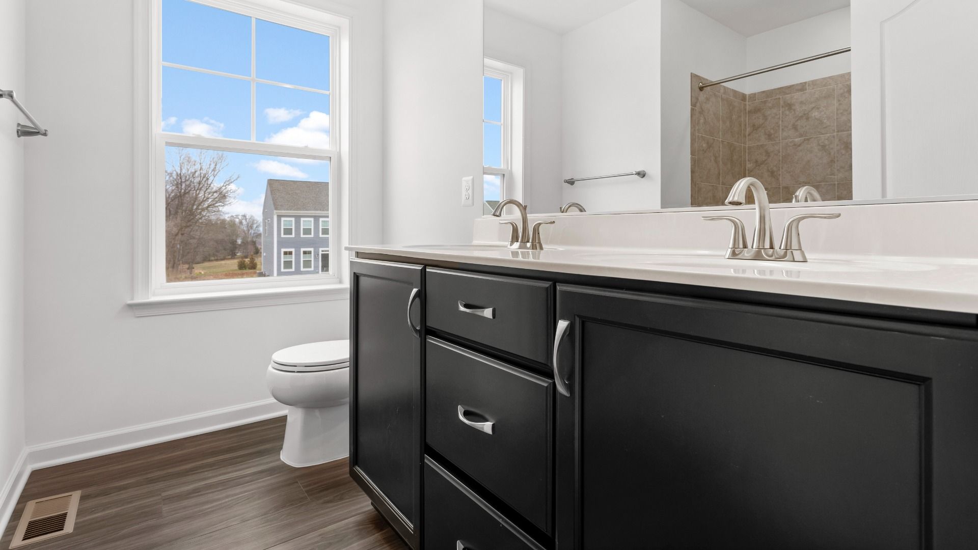 Full bath with dual sink vanity in a DRB Homes Bridgeport home plan at Huntfield in Charles Town, WV