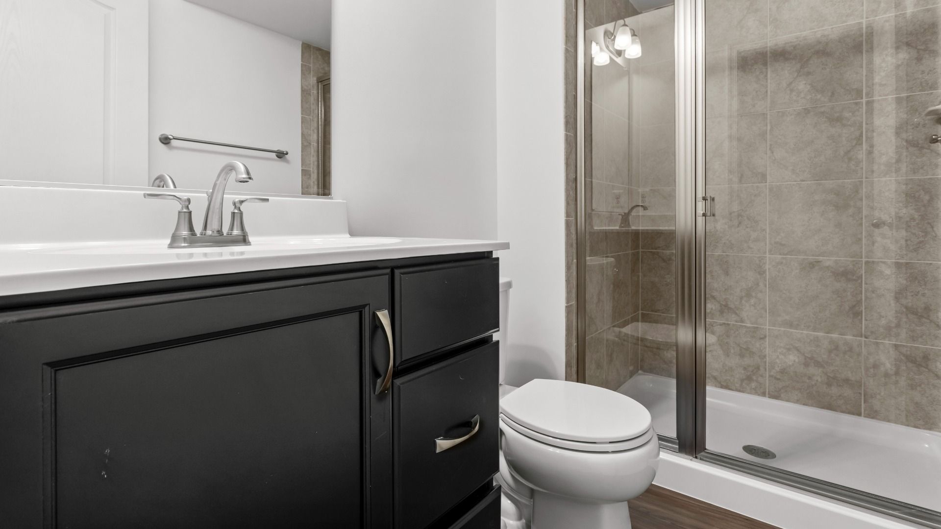 Lower level full bath with step-in shower in a DRB Homes Bridgeport home plan at Huntfield in Charles Town, WV