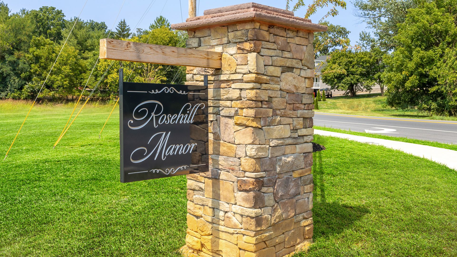 Entrance monument welcoming residents to the 55+ community, creating a stylish first impression.
