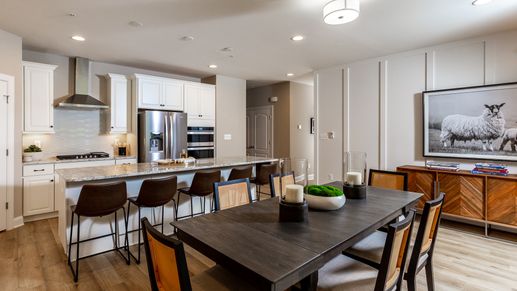 Kitchen and Dining Area with a Large Center Island and Range Hood in the DRB Homes Finch Model at Rosehill Manor