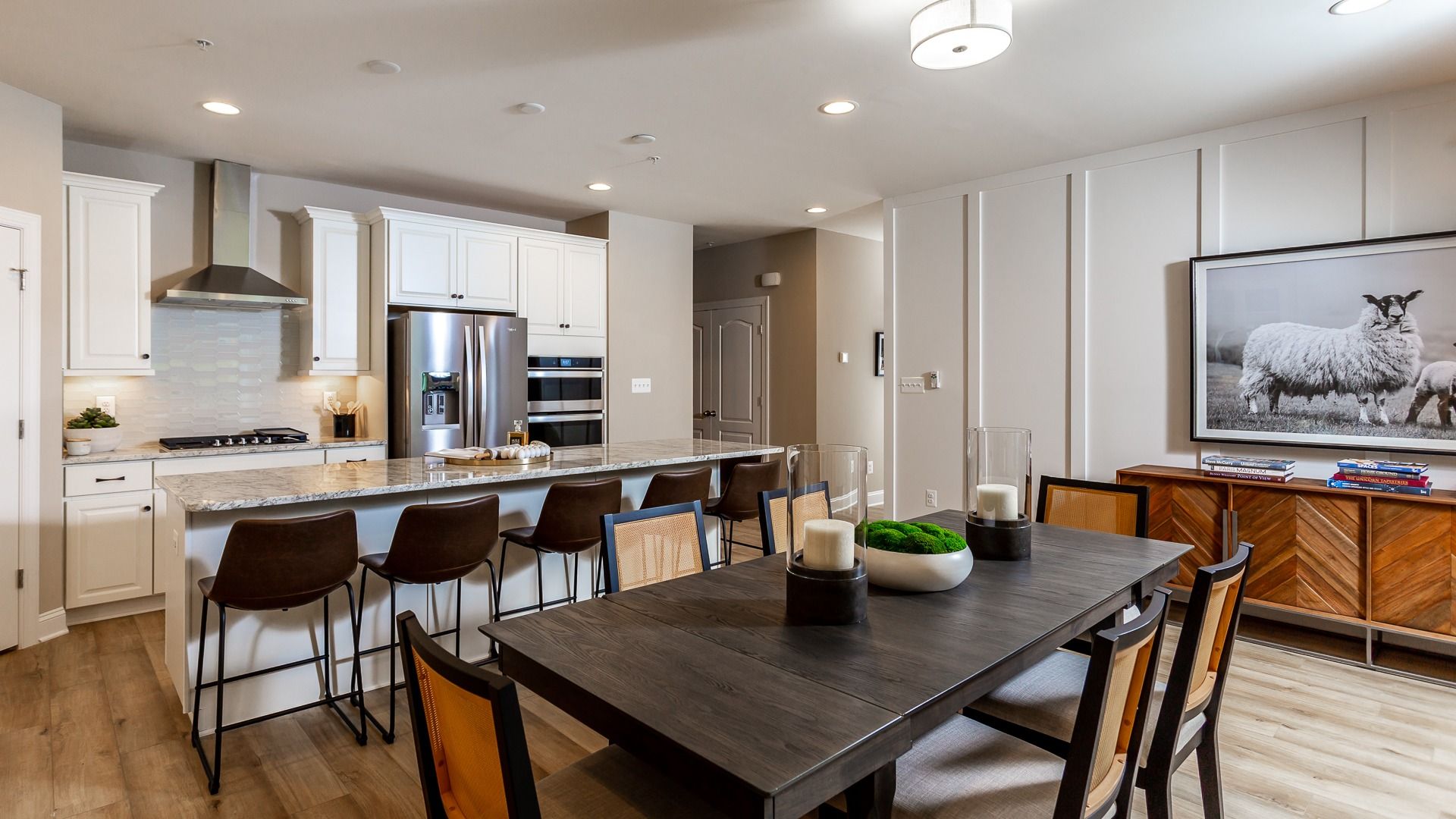 Kitchen and Dining Area with a Large Center Island and Range Hood in the DRB Homes Finch Model at Rosehill Manor
