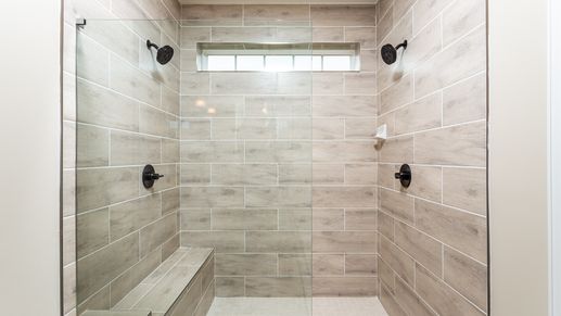The Owner's Bath Roman Shower in the DRB Homes Finch Model at Rosehill Manor