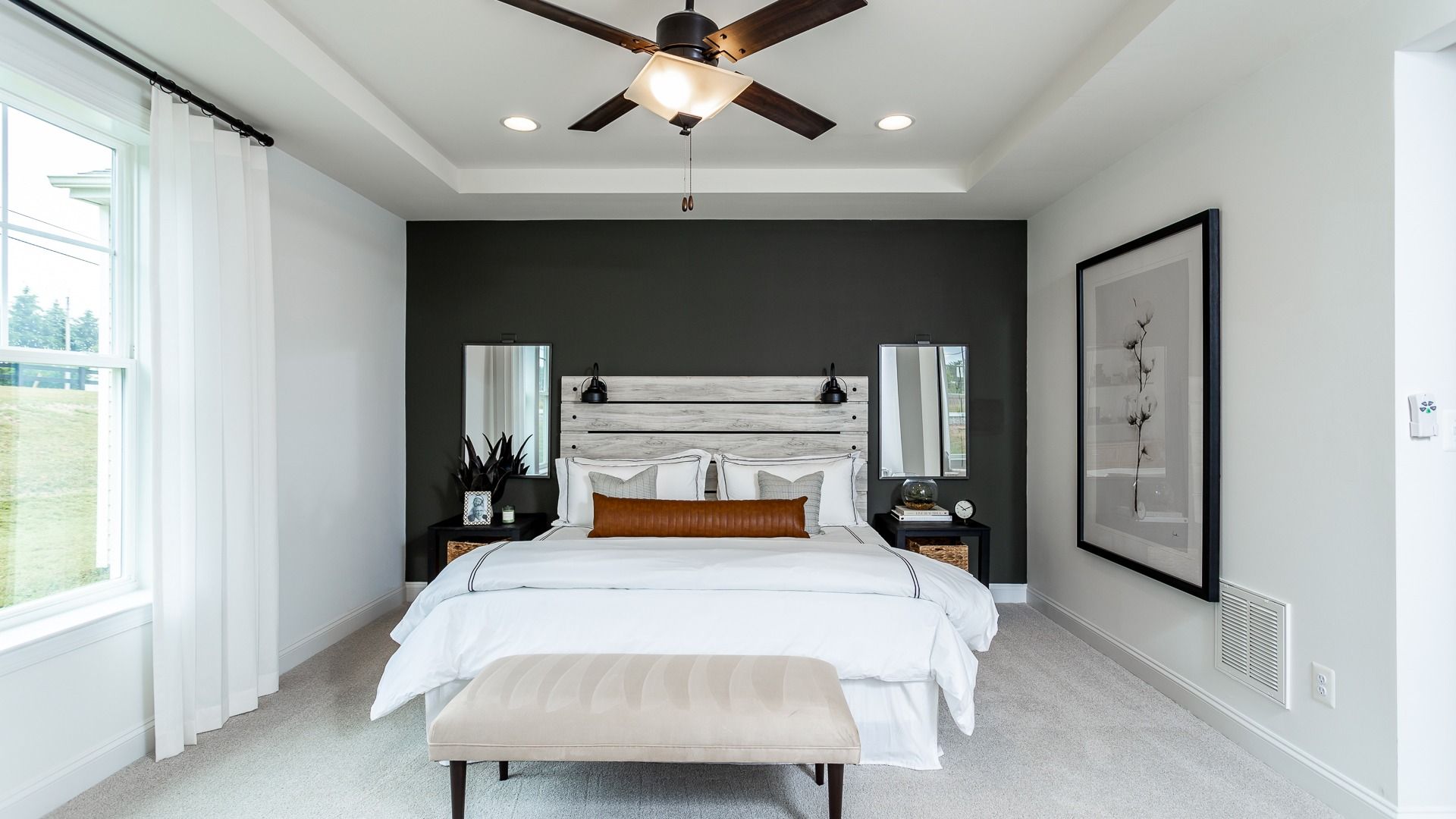 The Owner's Suite with a Queen-Sized Bed and Tray Ceiling in the DRB Homes Finch Model at Rosehill Manor