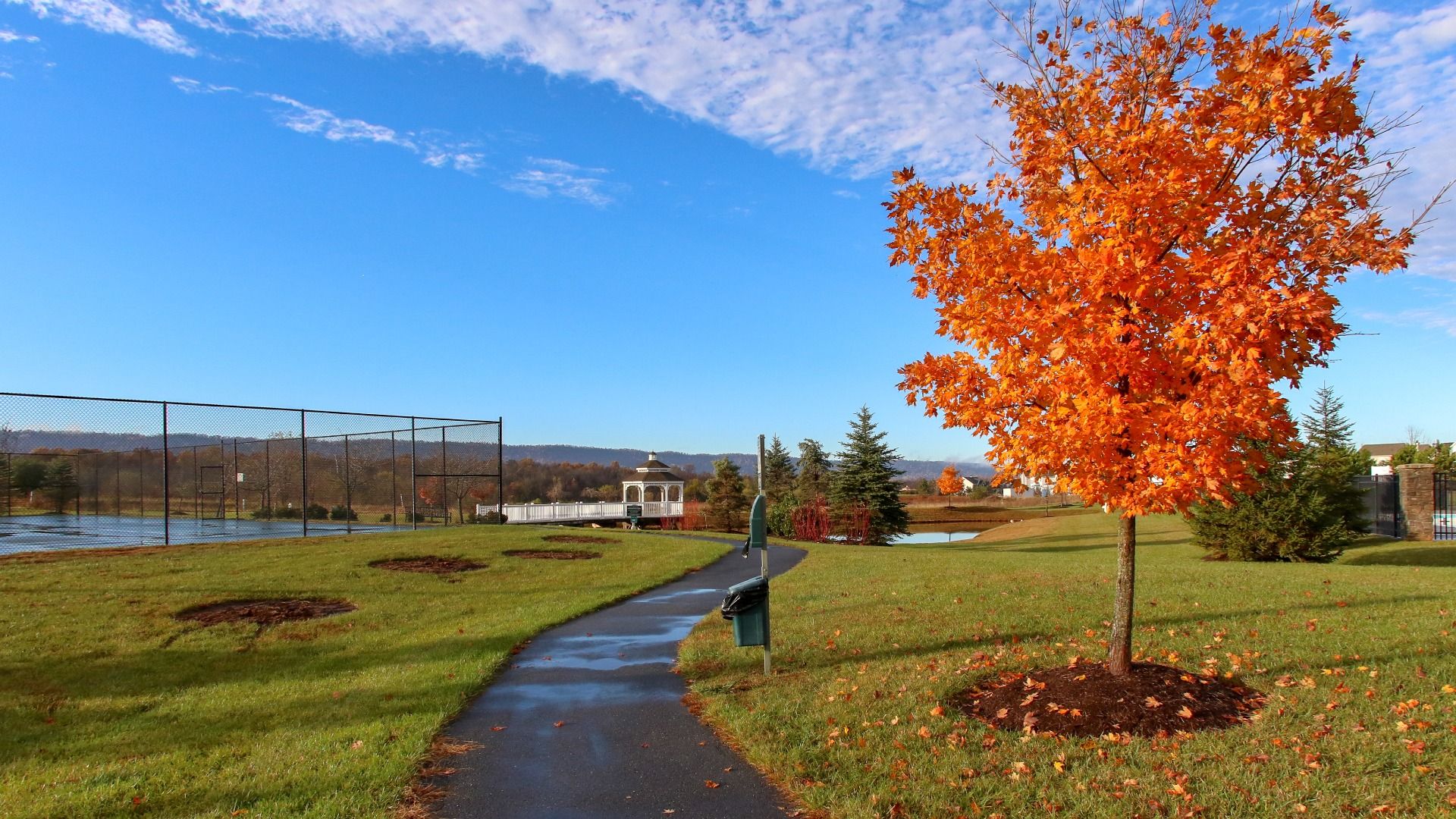 Autumn at Martinsburg Station, showcasing the community trail and tennis courts.
