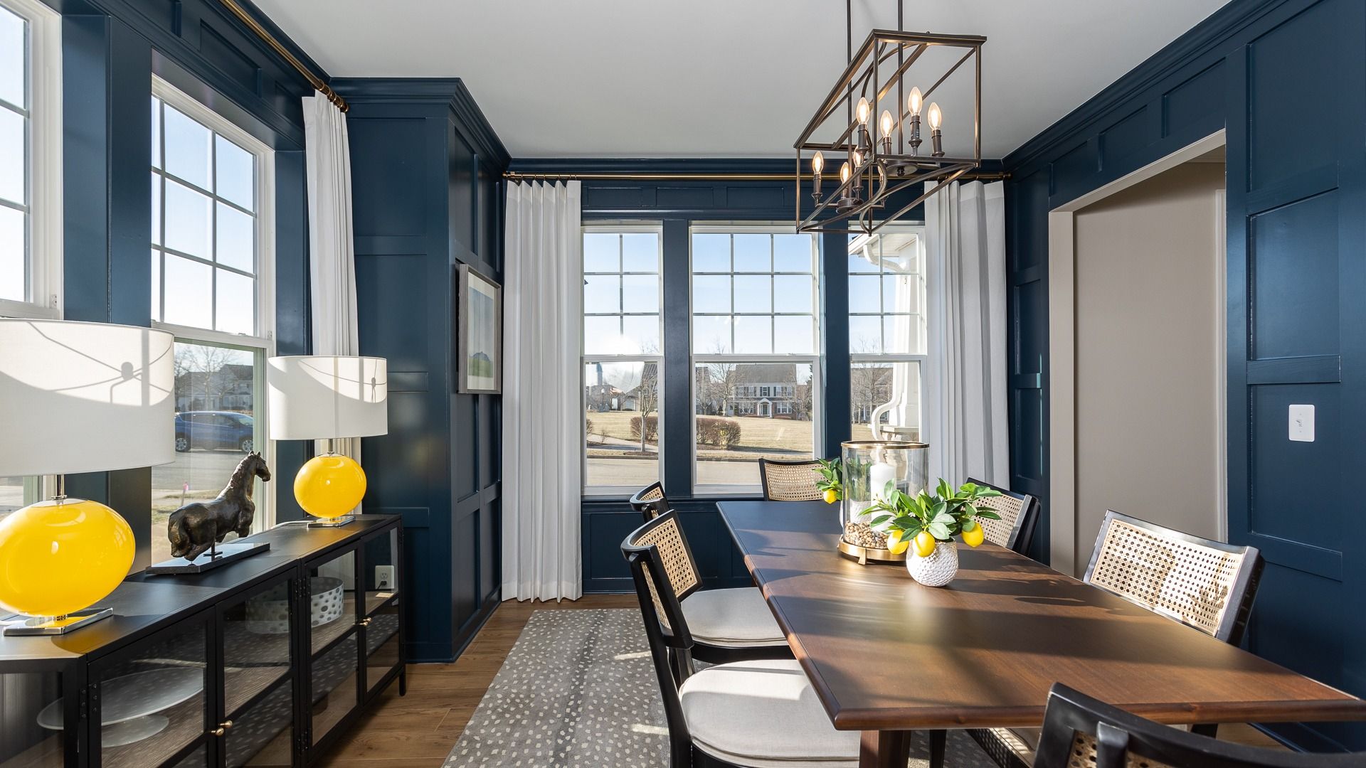 The dining room in the Clemson II floor plan is the perfect spot for gatherings, with a rectangular table and six chairs.