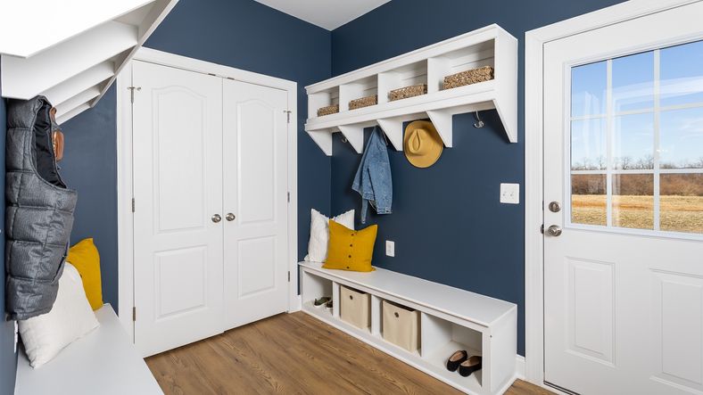 Functional mud room equipped with cubbies and hooks in the Clemson II floor plan.