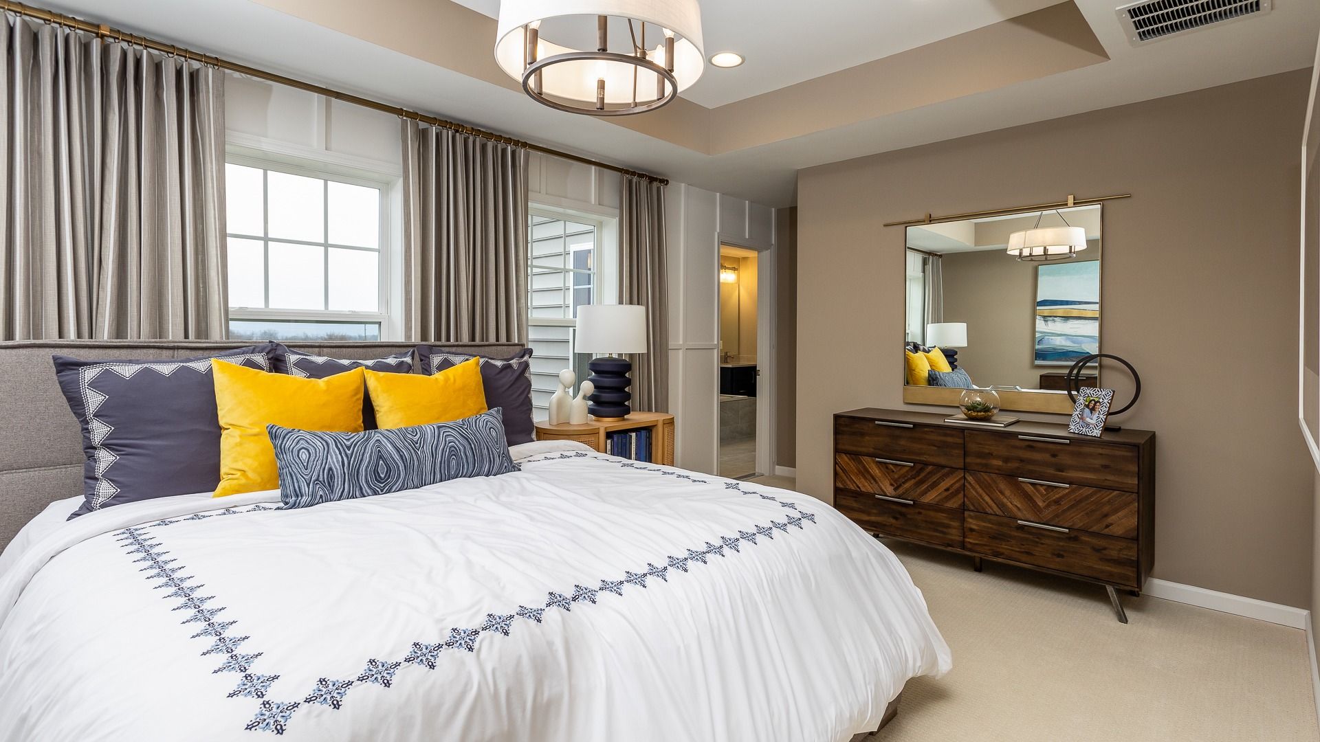 The spacious owner's suite with a queen-sized bed and tray ceiling in the Clemson II floor plan.