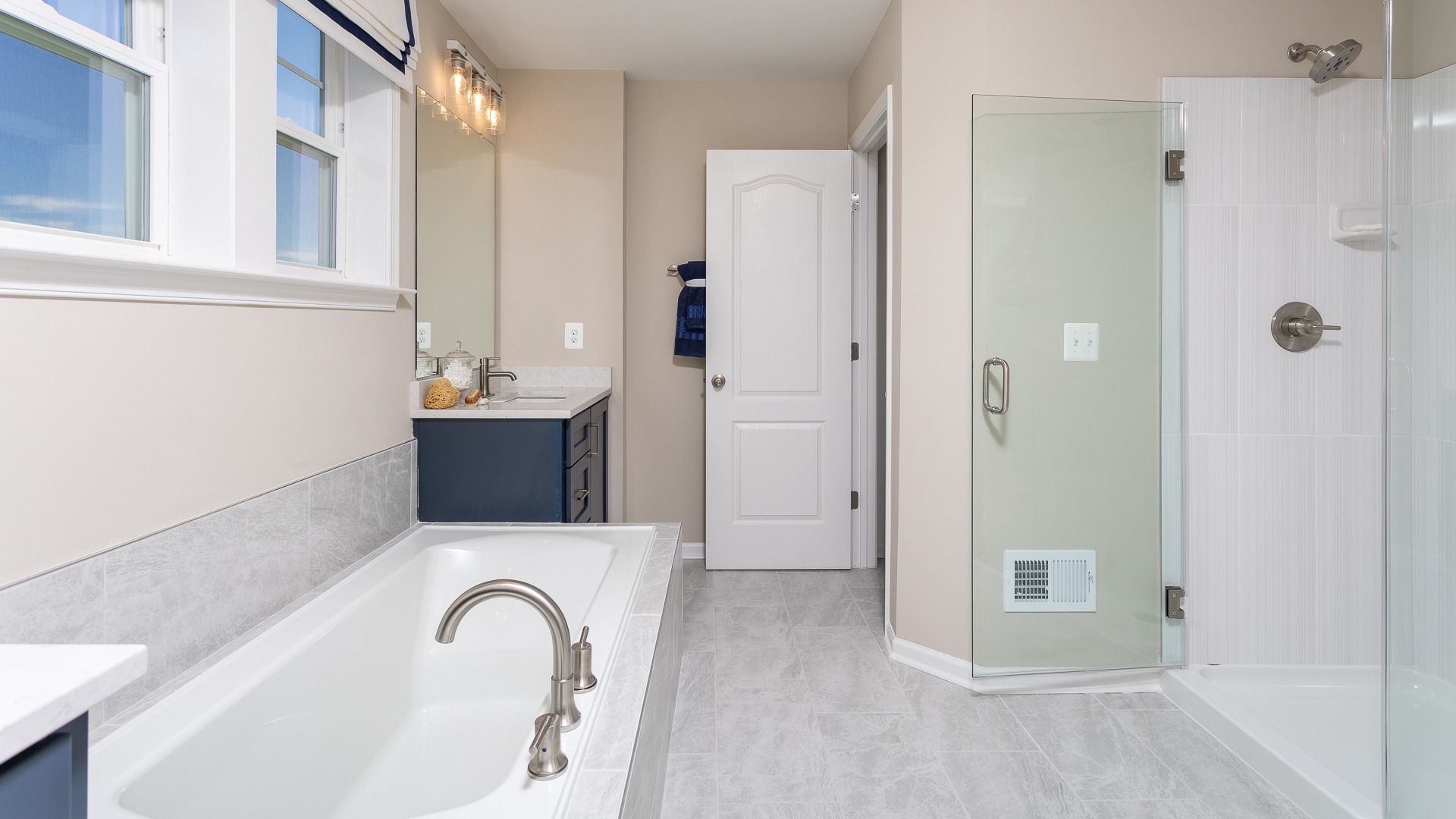 The owners bathroom in the Clemson II floor plans features a luxury soaking tub and roman shower.