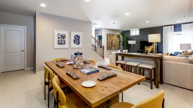 The finished lower level with functional dining area and comfortable seating in the Clemson II floor plan.