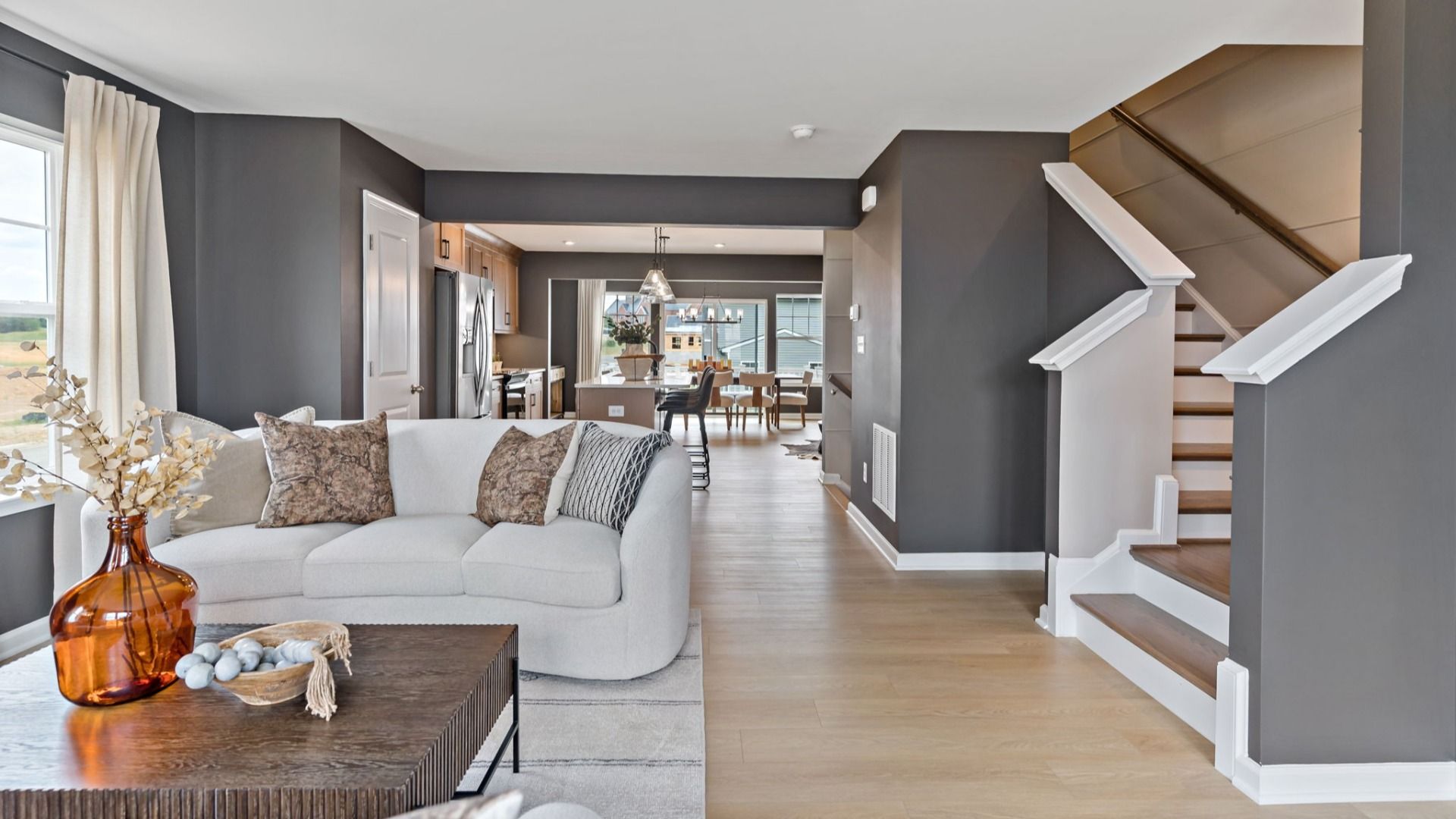 Spacious living room in a York II South Brook Townhome by DRB Homes, featuring modern decor and open floor plan in Inwood, WV