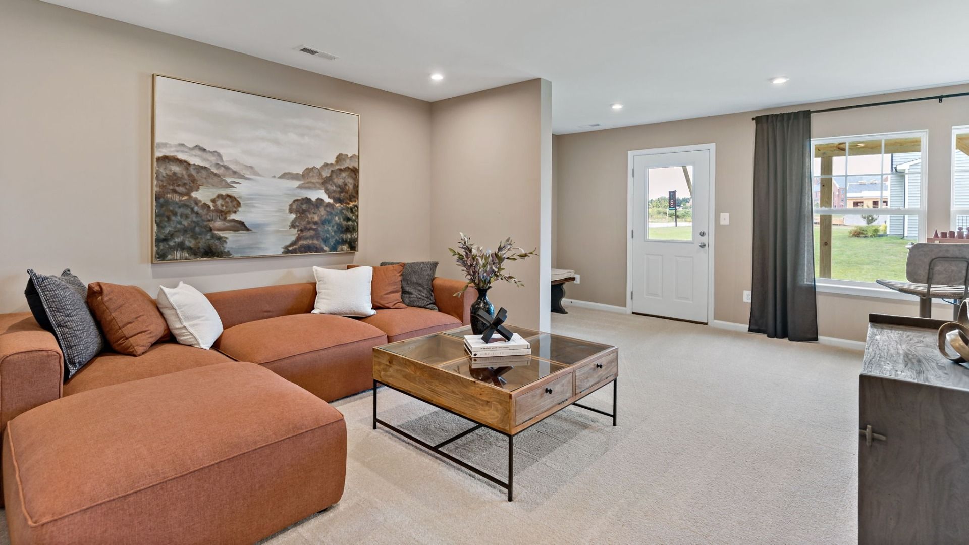 Spacious Lower-Level living room in a York II South Brook Townhome by DRB Homes, featuring modern decor in Inwood, WV.
