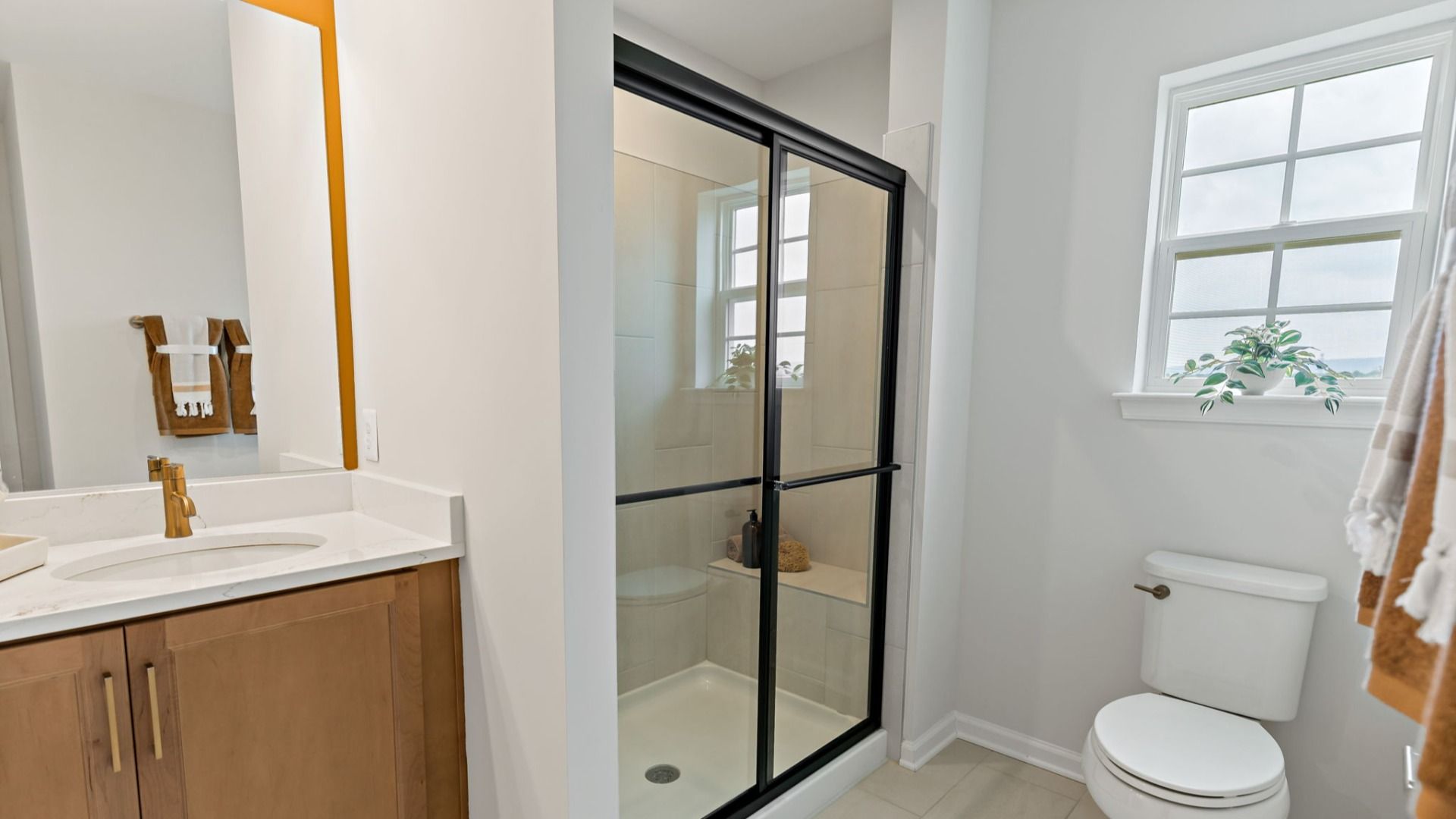 Modern bathroom view showing the shower, sink, and toilet in a South Brook home, Inwood, WV, highlighting contemporary design