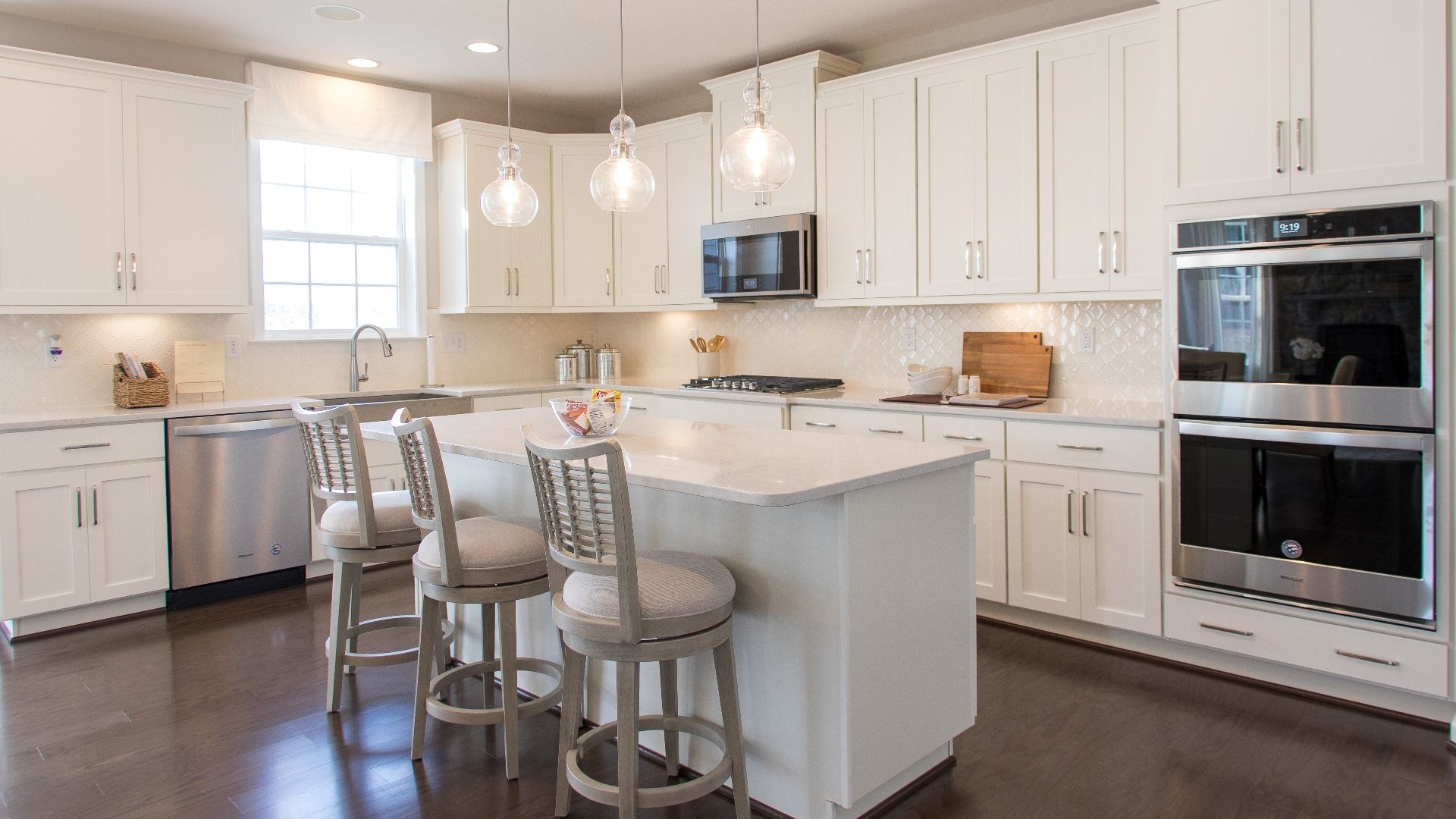 Island kitchen with window of sink in a DRB Homes Cypress II home plan at Huntfield.