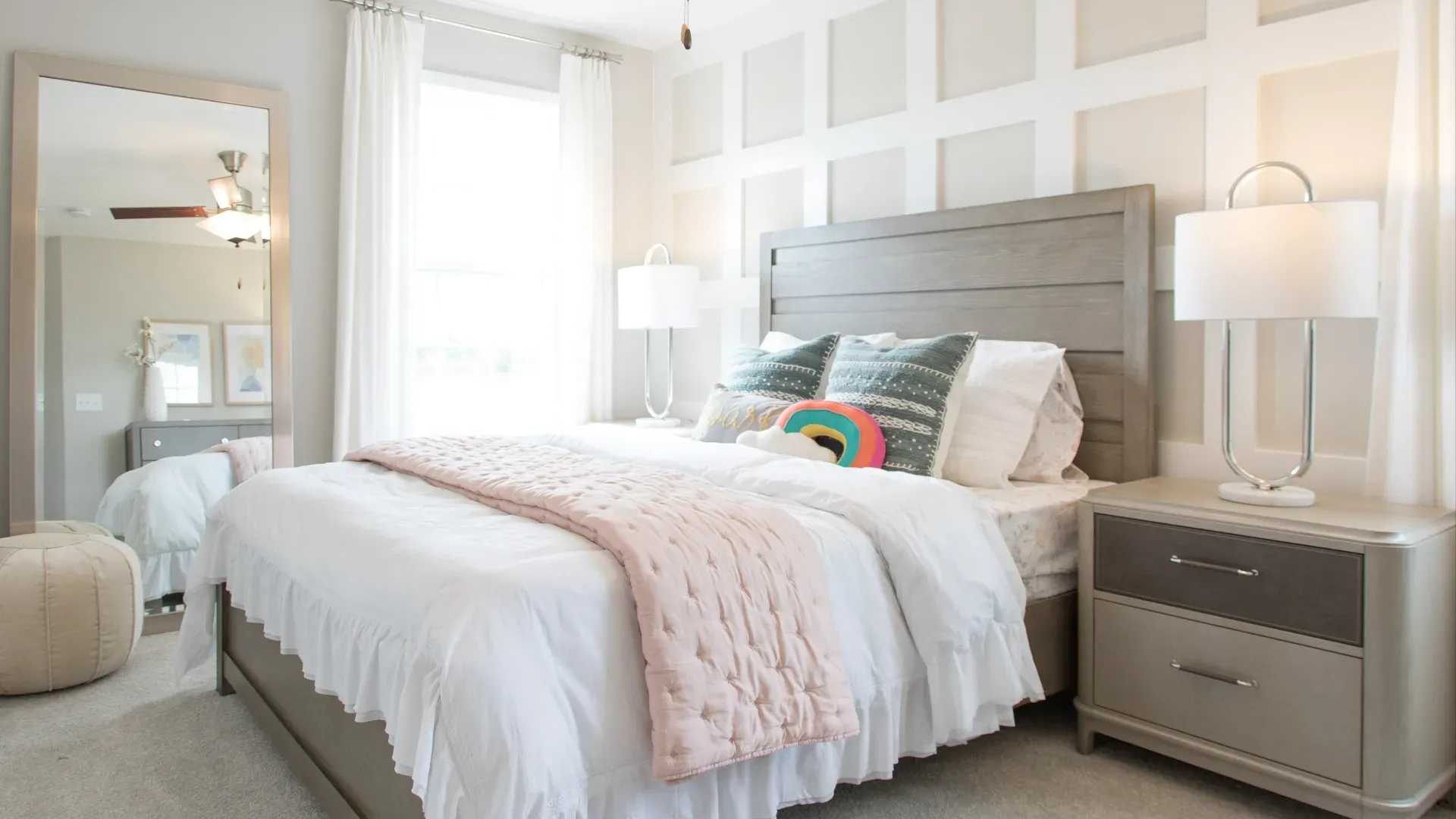 Carpeted secondary bedroom with large single window in a DRB Homes Cypress II home plan at Huntfield.
