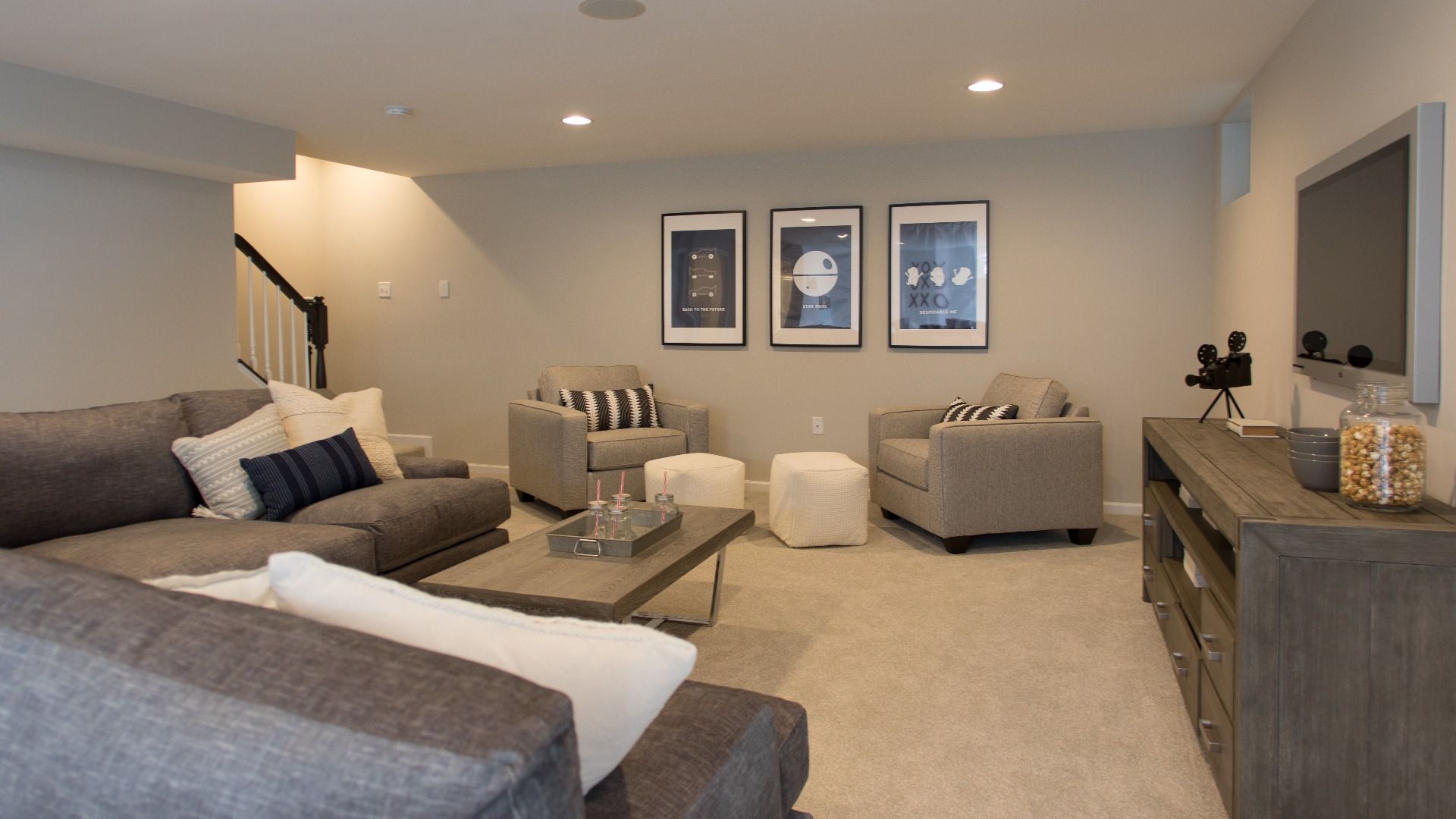 Finished lower level with seating in a DRB Homes Cypress II home plan at Huntfield.