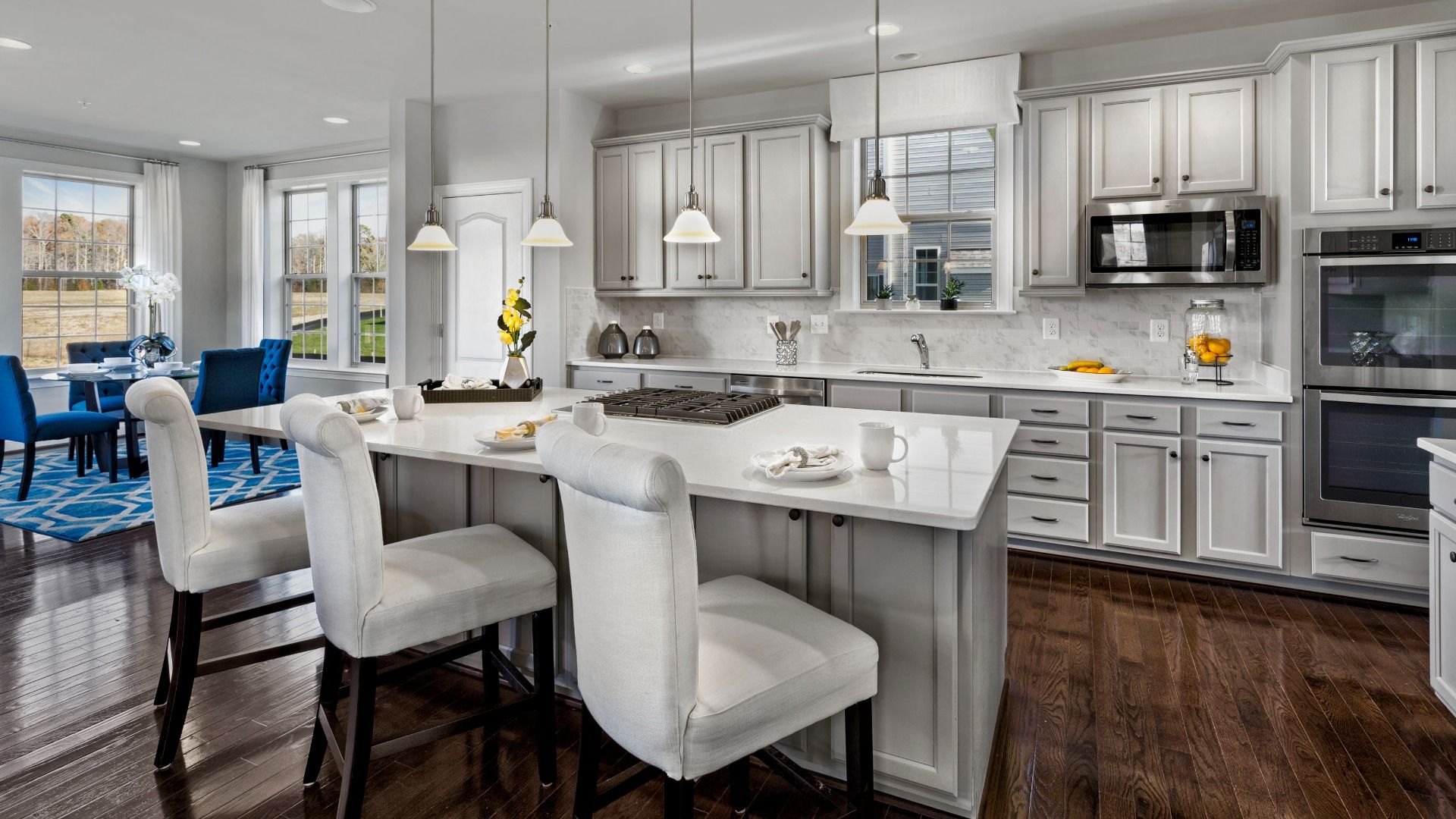 Open kitchen with large island in a DRB Homes Newbury II home plan at Huntfield.
