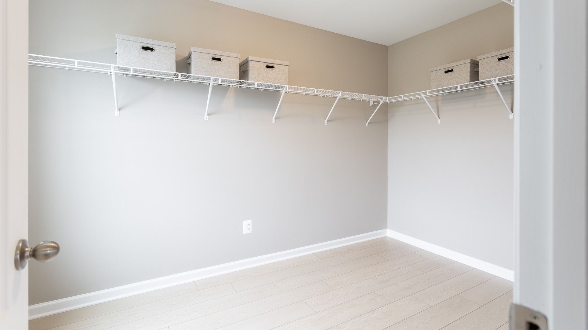 Spacious walk-in closet in the Oakdale II plan owners bedroom, with ample built-in shelving and hanging storage solutions.