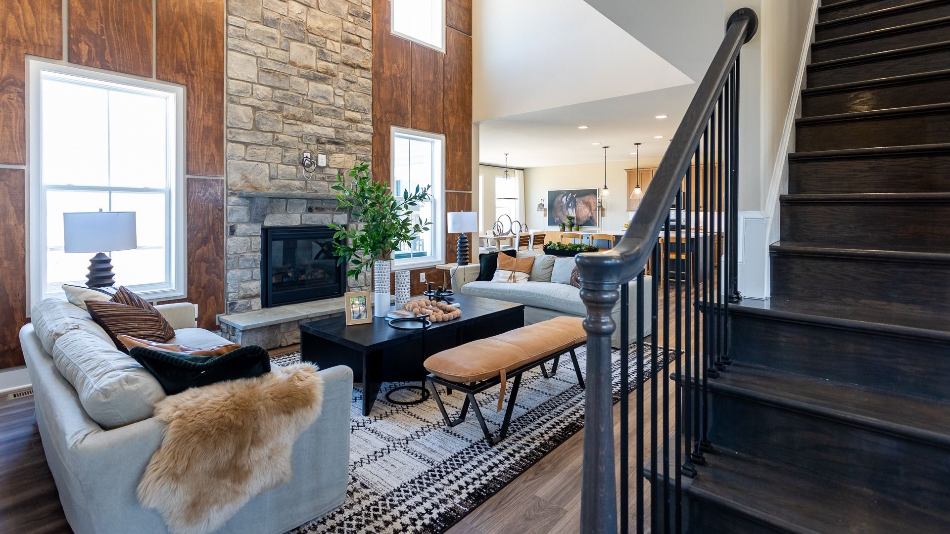 2-Story family room with stone fireplace in a DRB Homes Castlerock II home plan at Huntfield