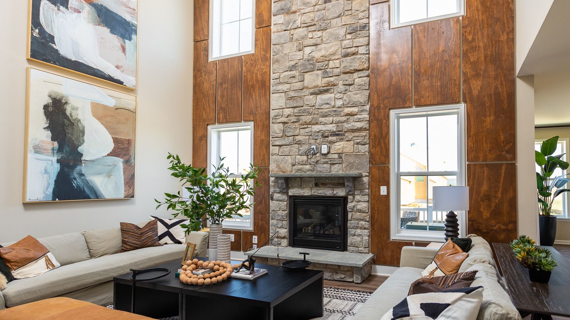 2-Story family room with stone fireplace in a DRB Homes Castlerock II home plan at Huntfield.