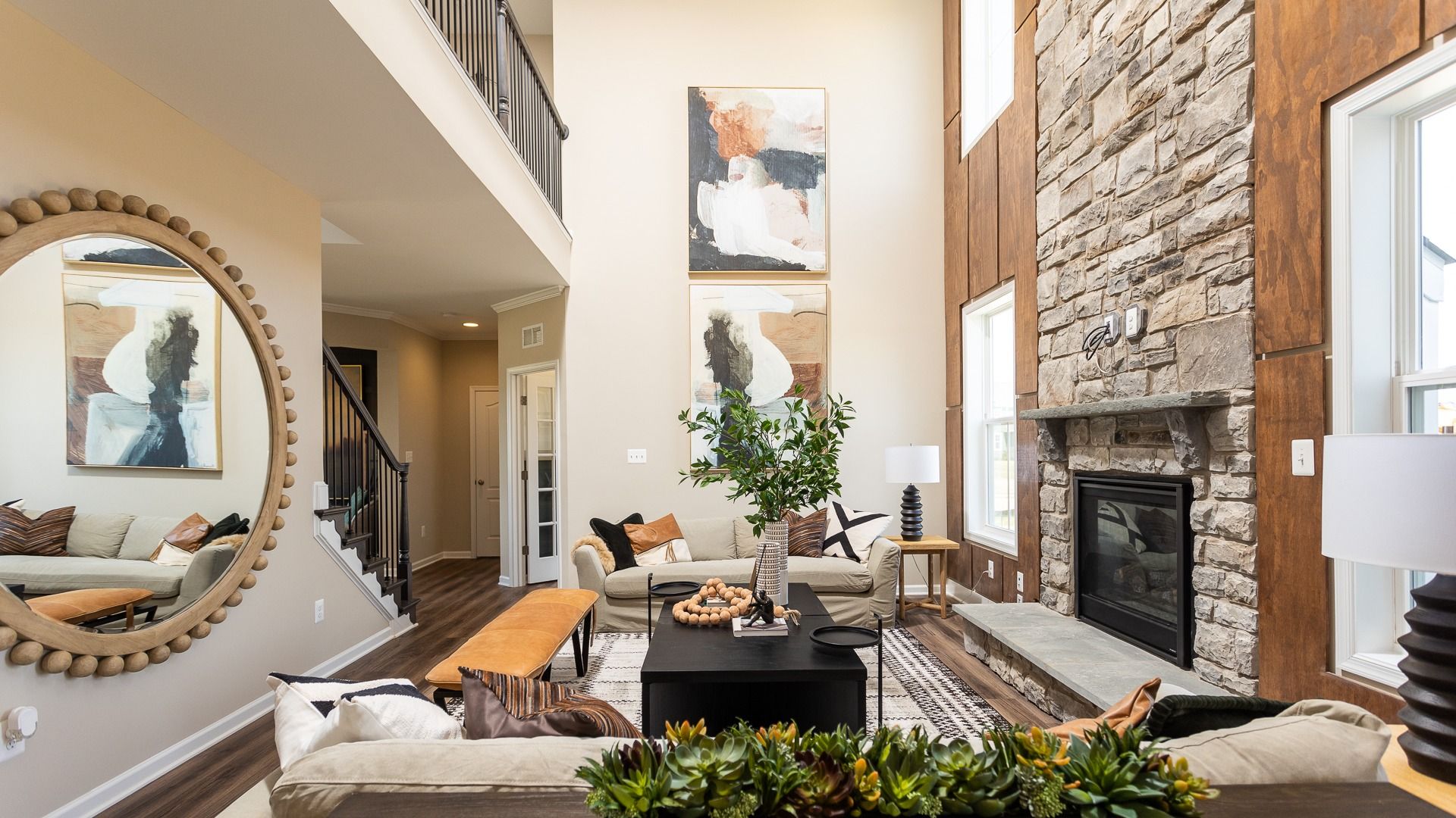 2-Story family room with stone fireplace in a DRB Homes Castlerock II home plan in Huntfield.