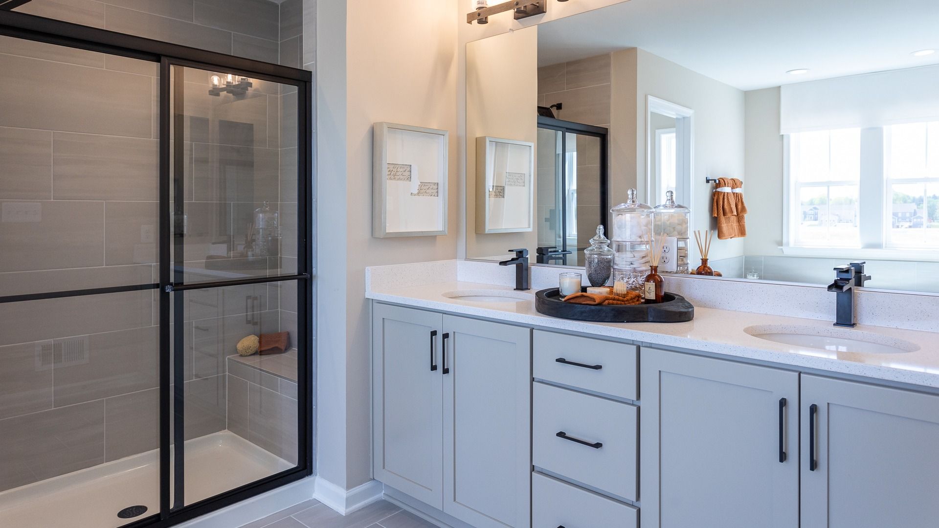 Owner's bath with dual sink vanity and step-in shower in a DRB Homes Castlerock II home plan at Huntfield.