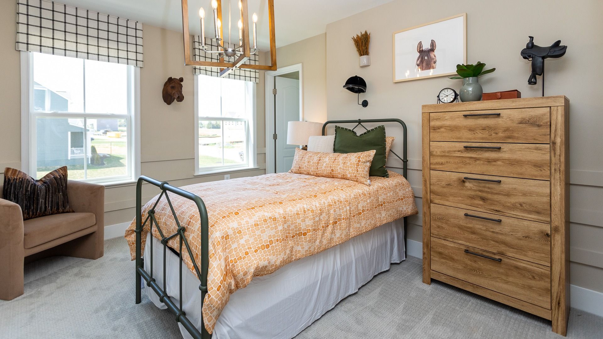 Carpeted secondary bedroom with 2 windows in a DRB Homes Castlerock II home plan at Huntfield.
