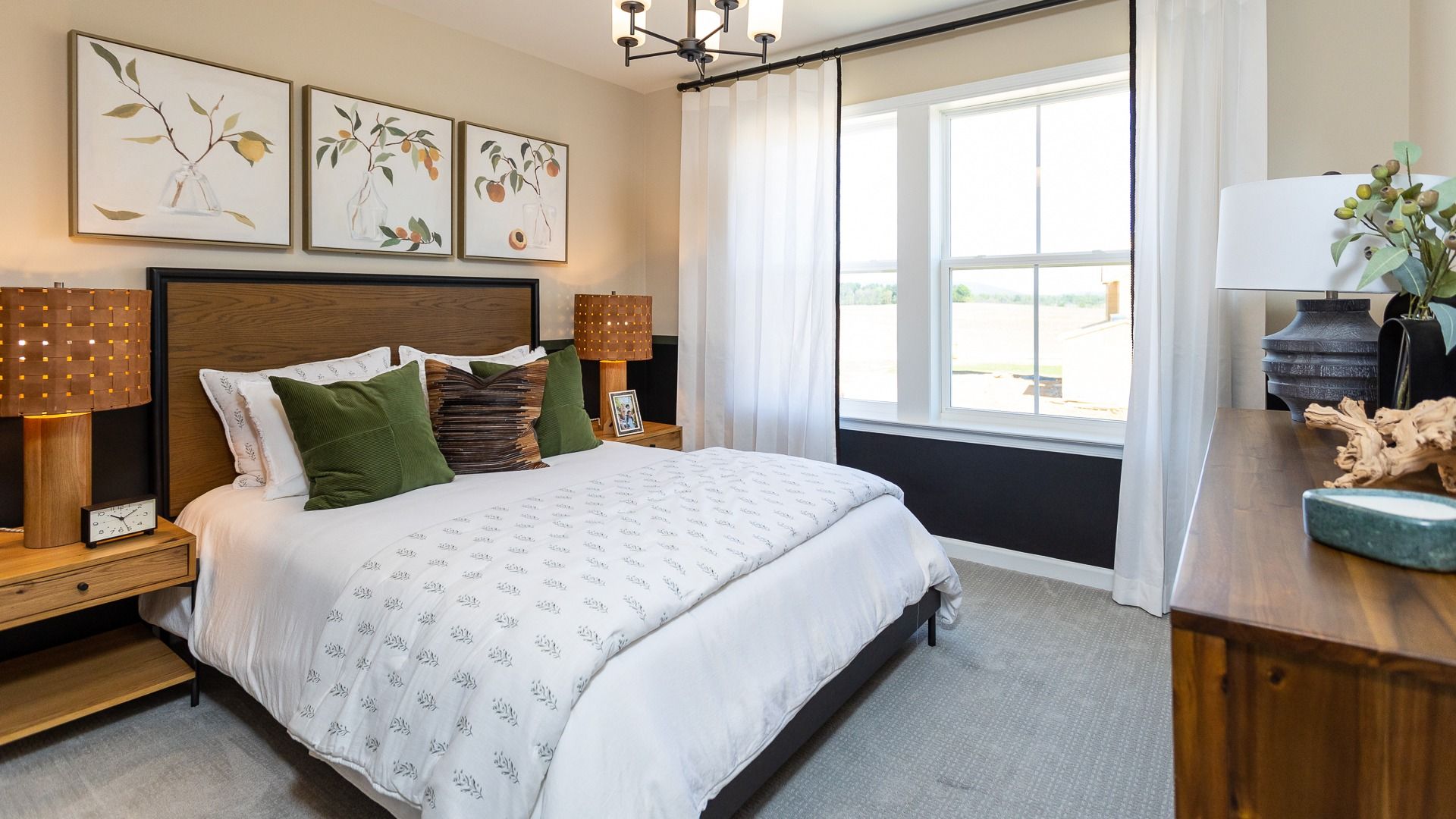 Carpeted secondary bedroom with double window in a DRB Homes Castlerock II home plan at Huntfield.