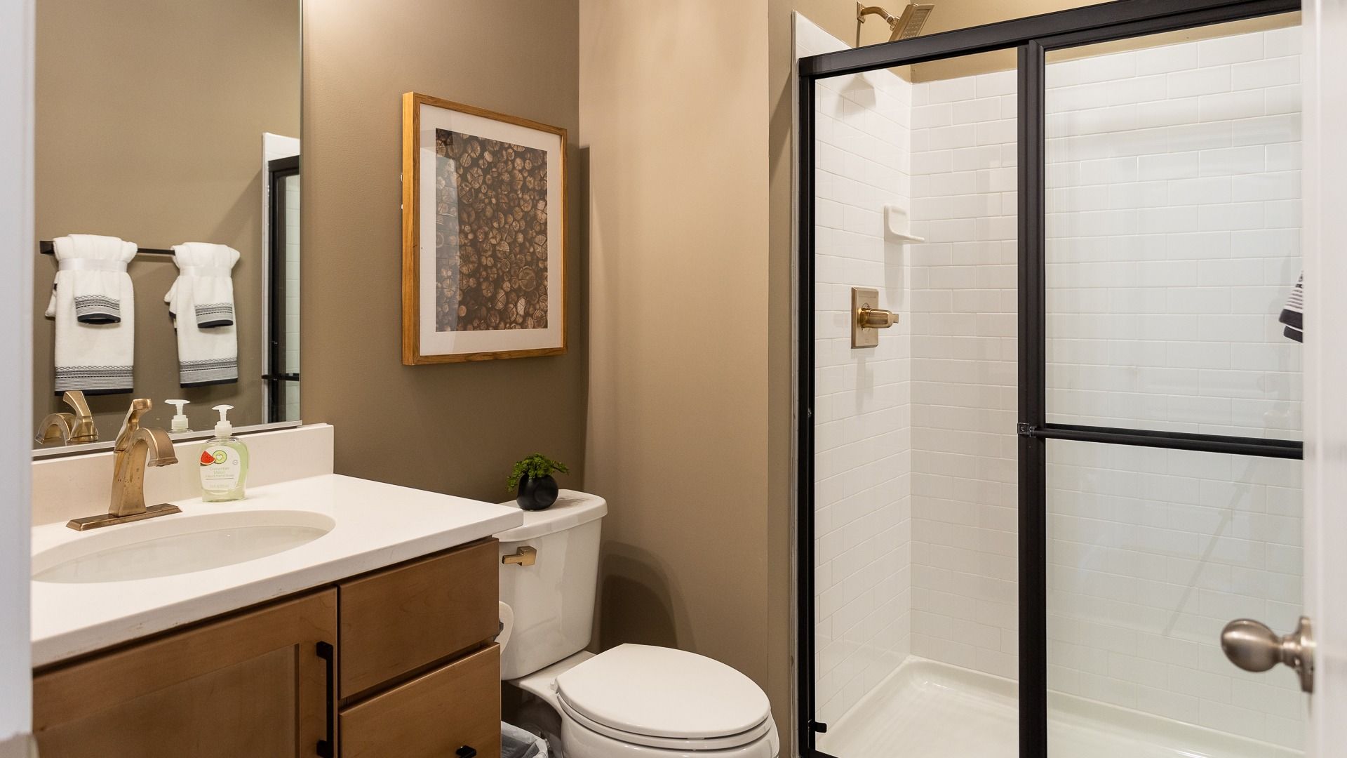 Lower level bathroom with walk-in shower s in a DRB Homes Castlerock II model in the Aspen Greens community.