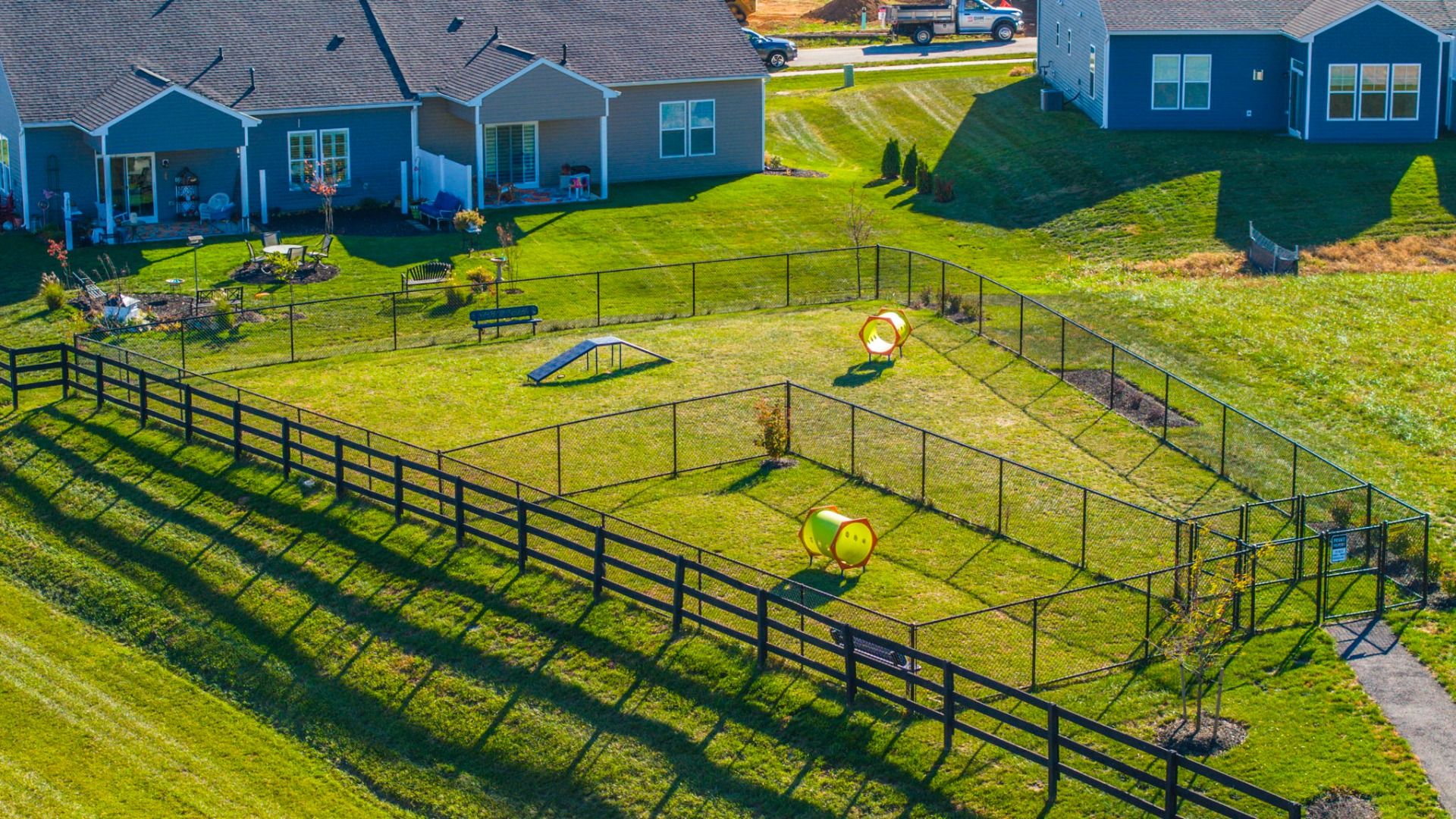 Drone photo of the exterior view of Rosehill Manor, with a large field and dog park.